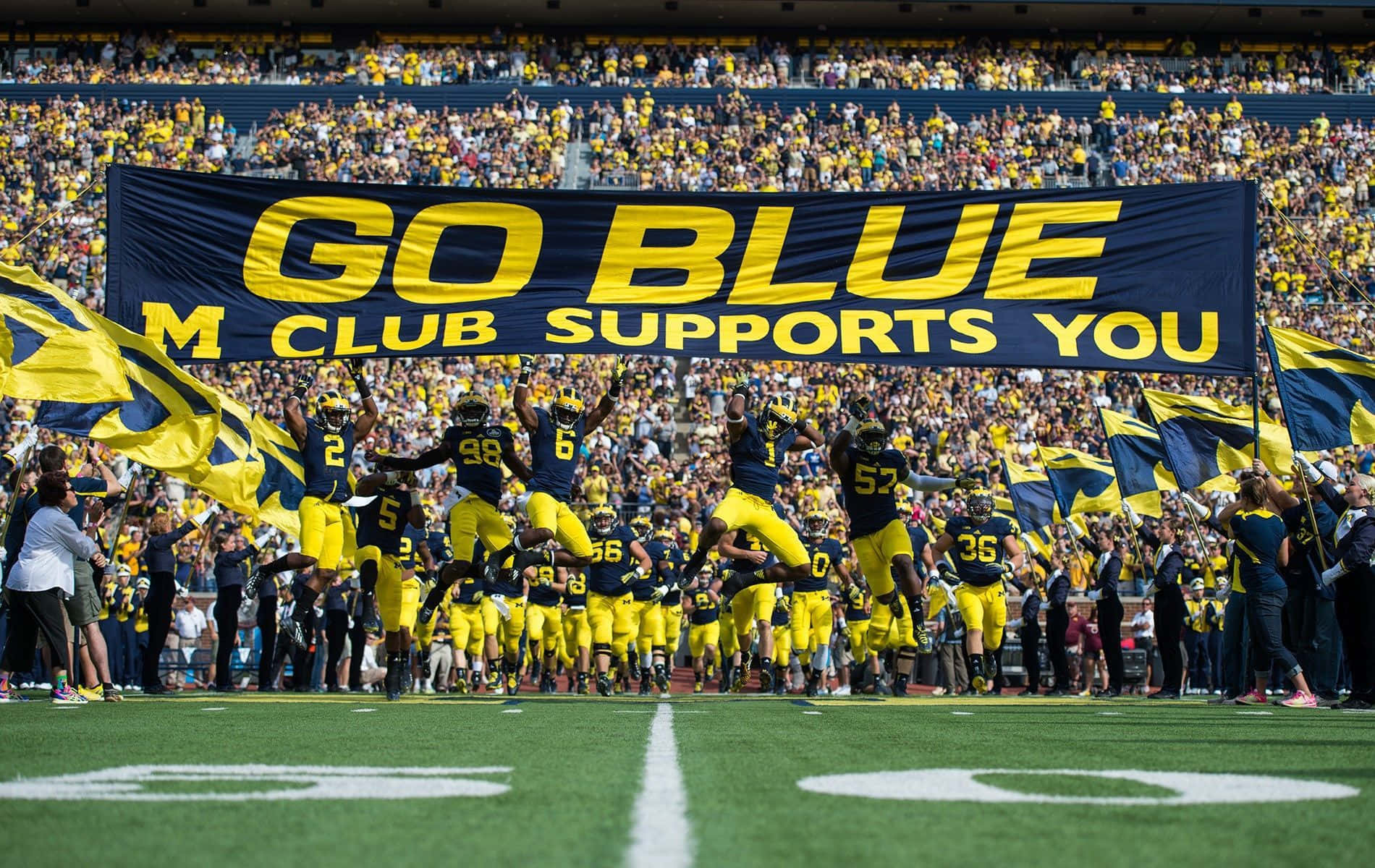 Michigan Wolverines football team in action on the field Wallpaper