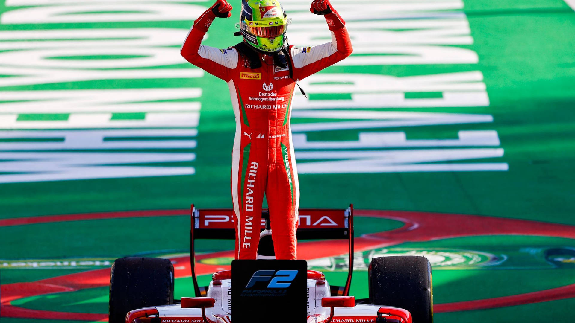 Mick Schumacher Standing With Raised Fists Wallpaper