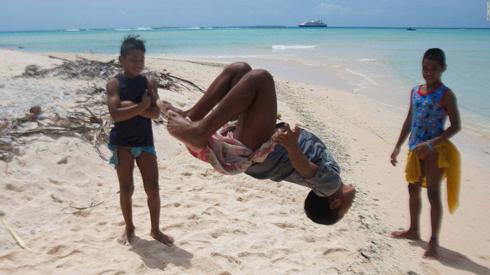 Micronesia Dreng, der laver et baglæns spring mod solnedgangsscenen Wallpaper