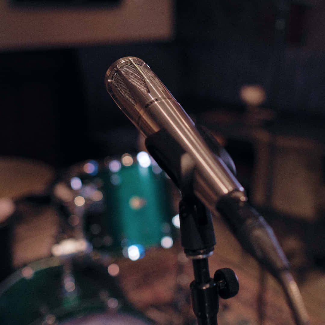 A Microphone Is Sitting On A Drum Set