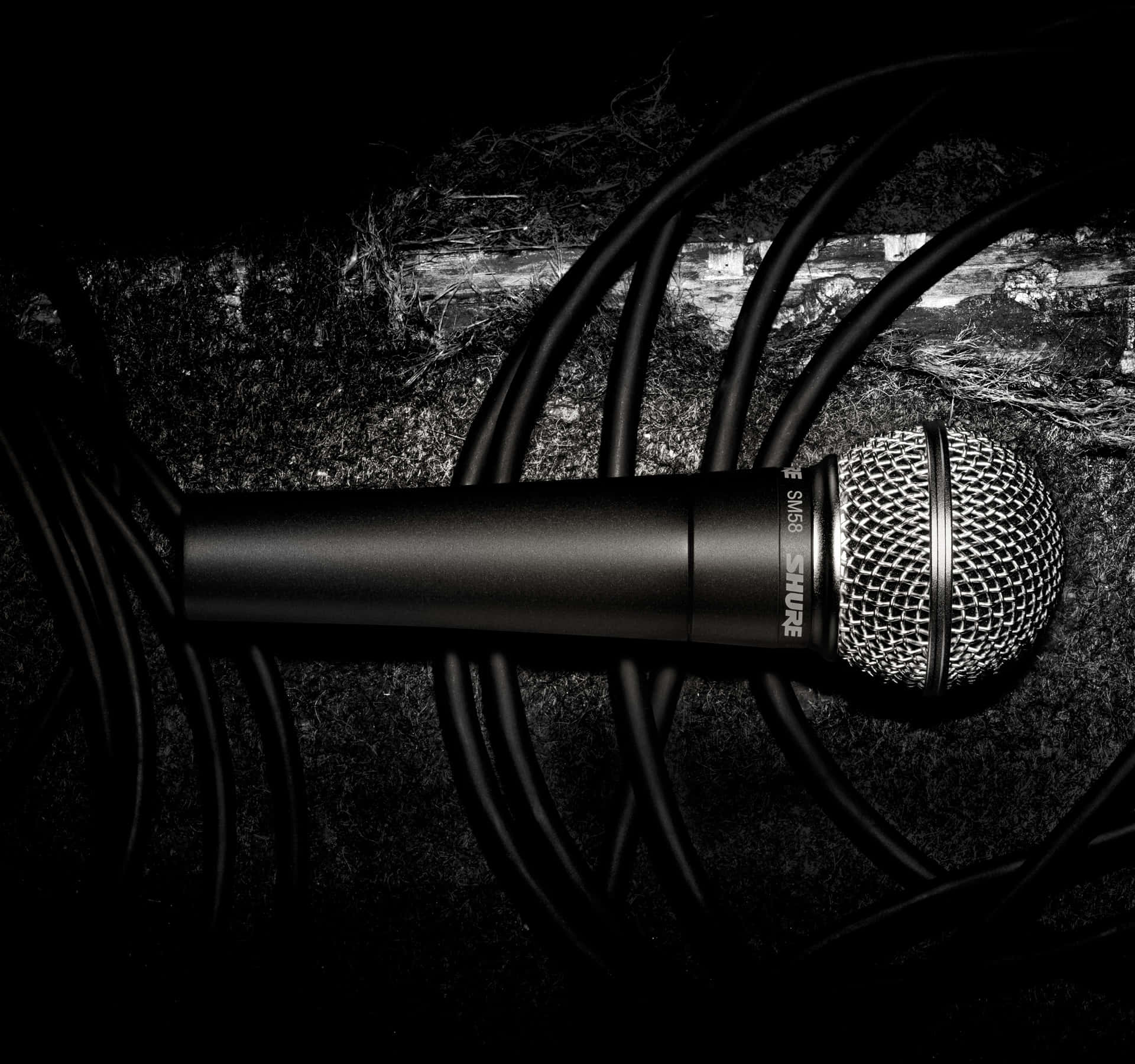 A Microphone Is Laying On A Black Background