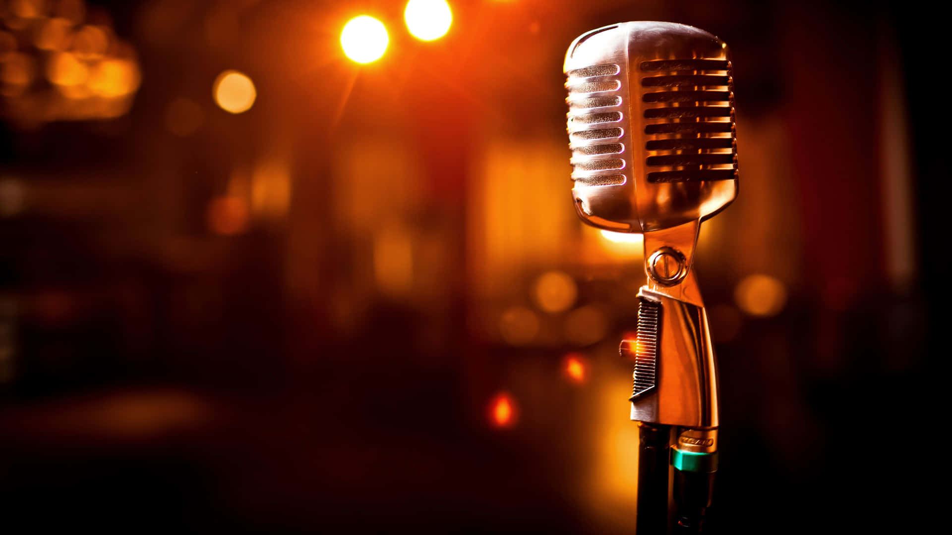 A Microphone Is Sitting On A Stage In Front Of A Dark Background