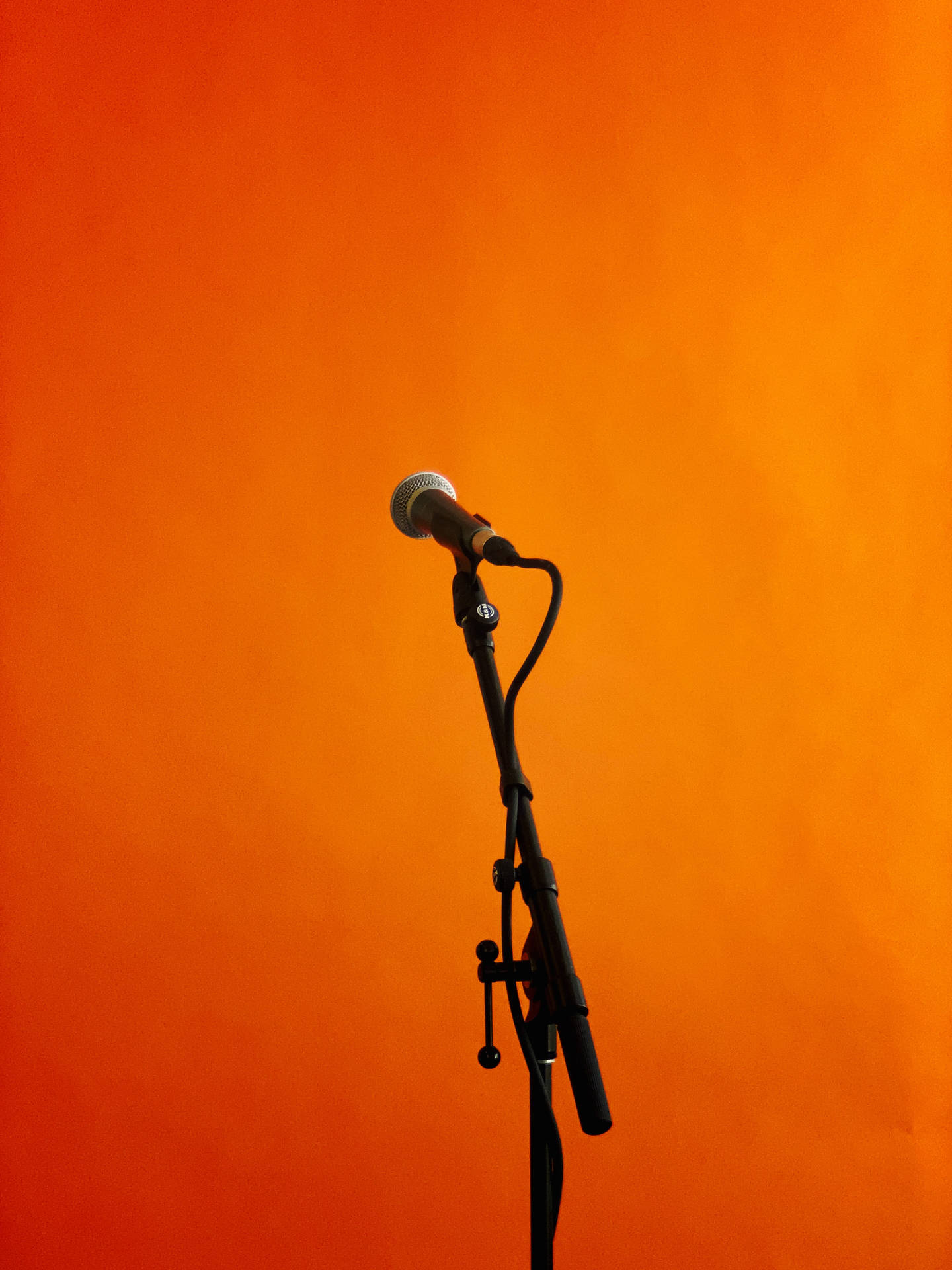Microphone Stand Against Orange Backdrop SVG