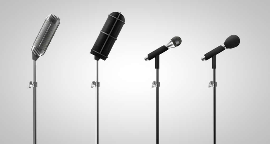 A fascinating display of vintage microphones against a cool, dark backdrop.