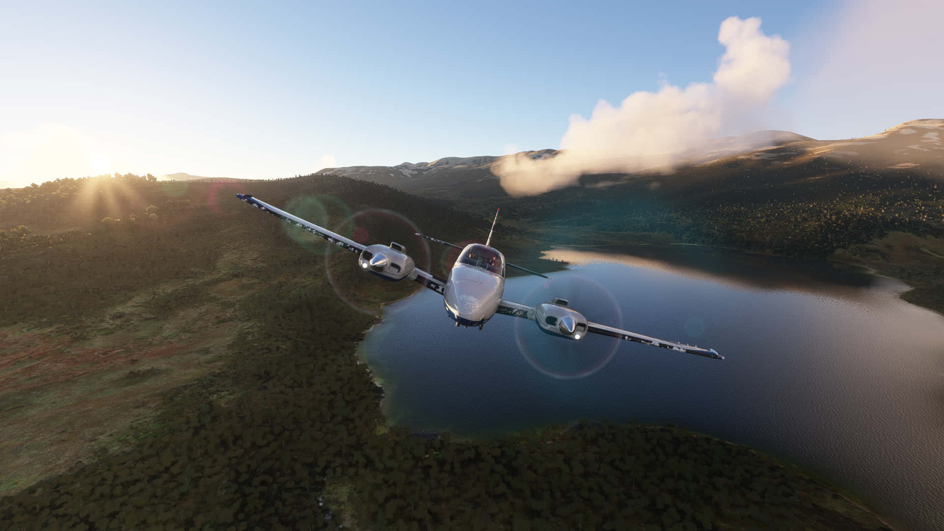 A Plane Flying Over A Lake And Mountains
