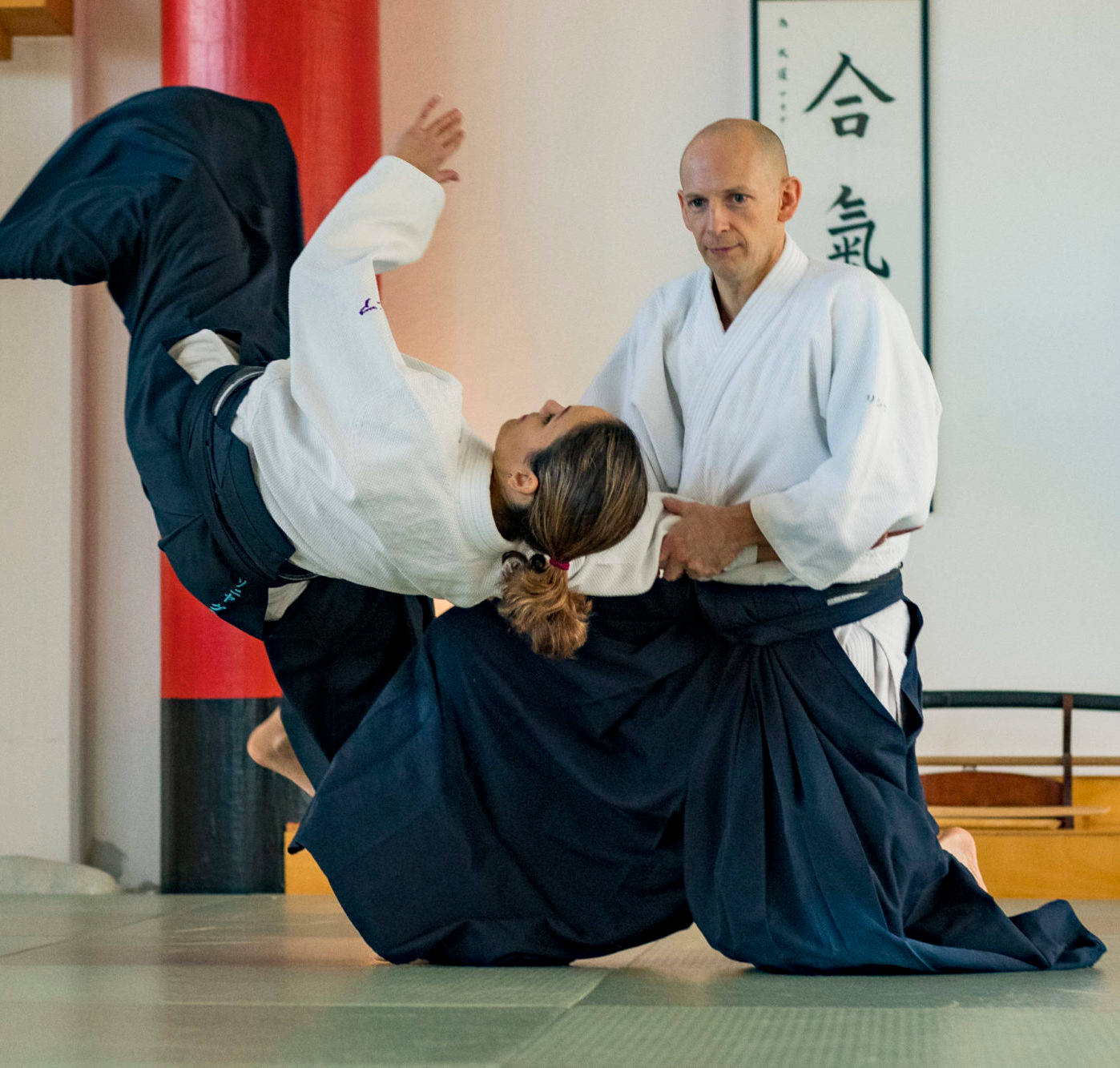 Perfect Execution of Aikido's Koshi Nage Technique Wallpaper