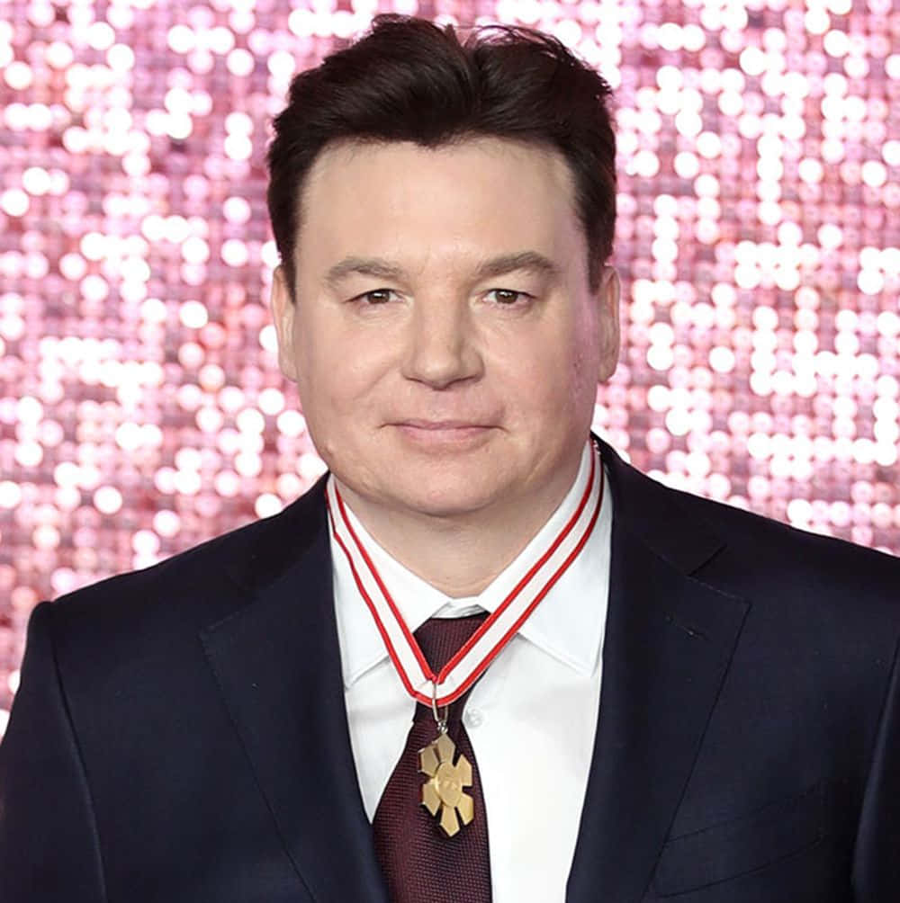 Mike Myers looking confident against an orange background Wallpaper