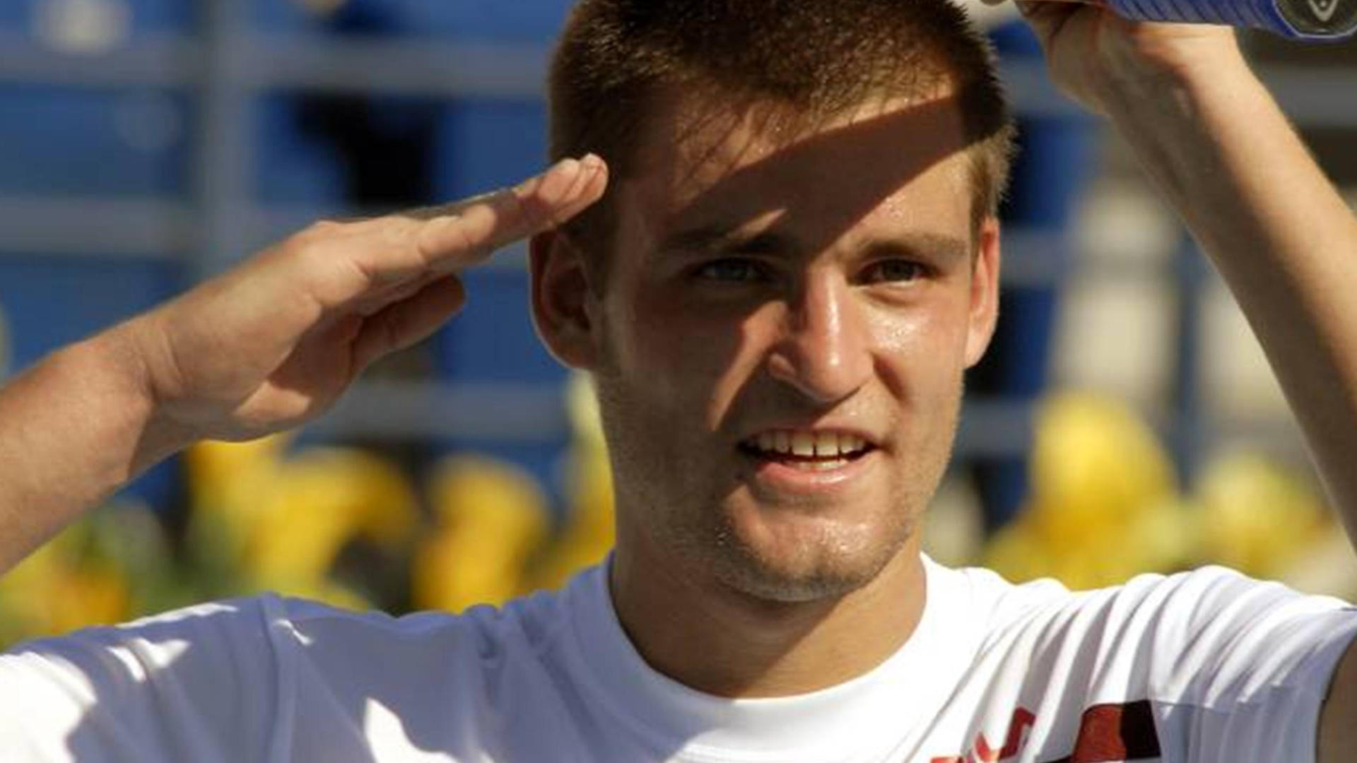 Mikhail Youzhny performing his signature hand salute on the court Wallpaper