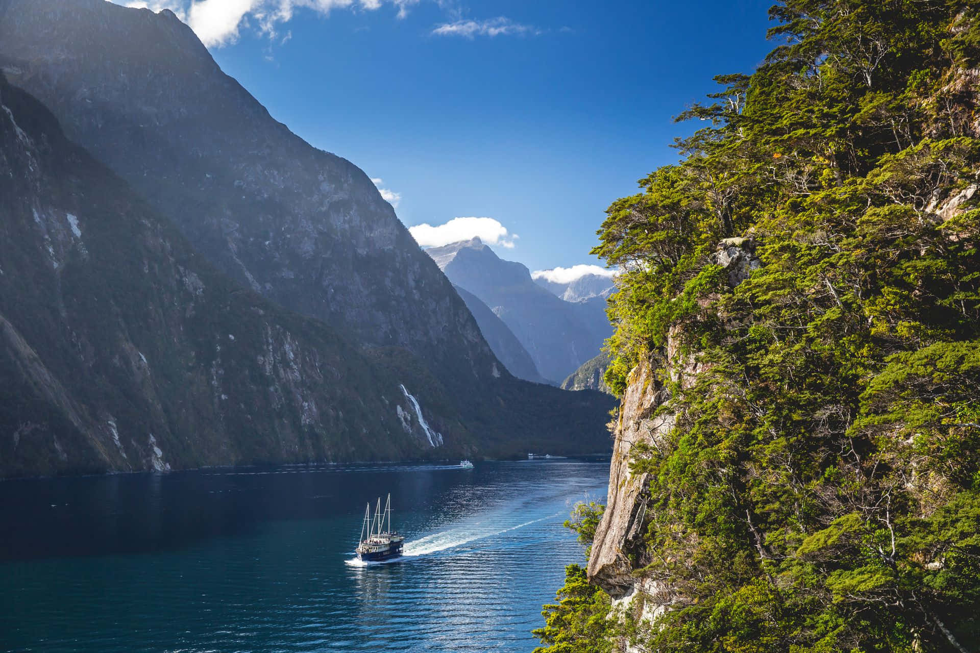 Milford Sound Ship Sailing In Waters Wallpaper