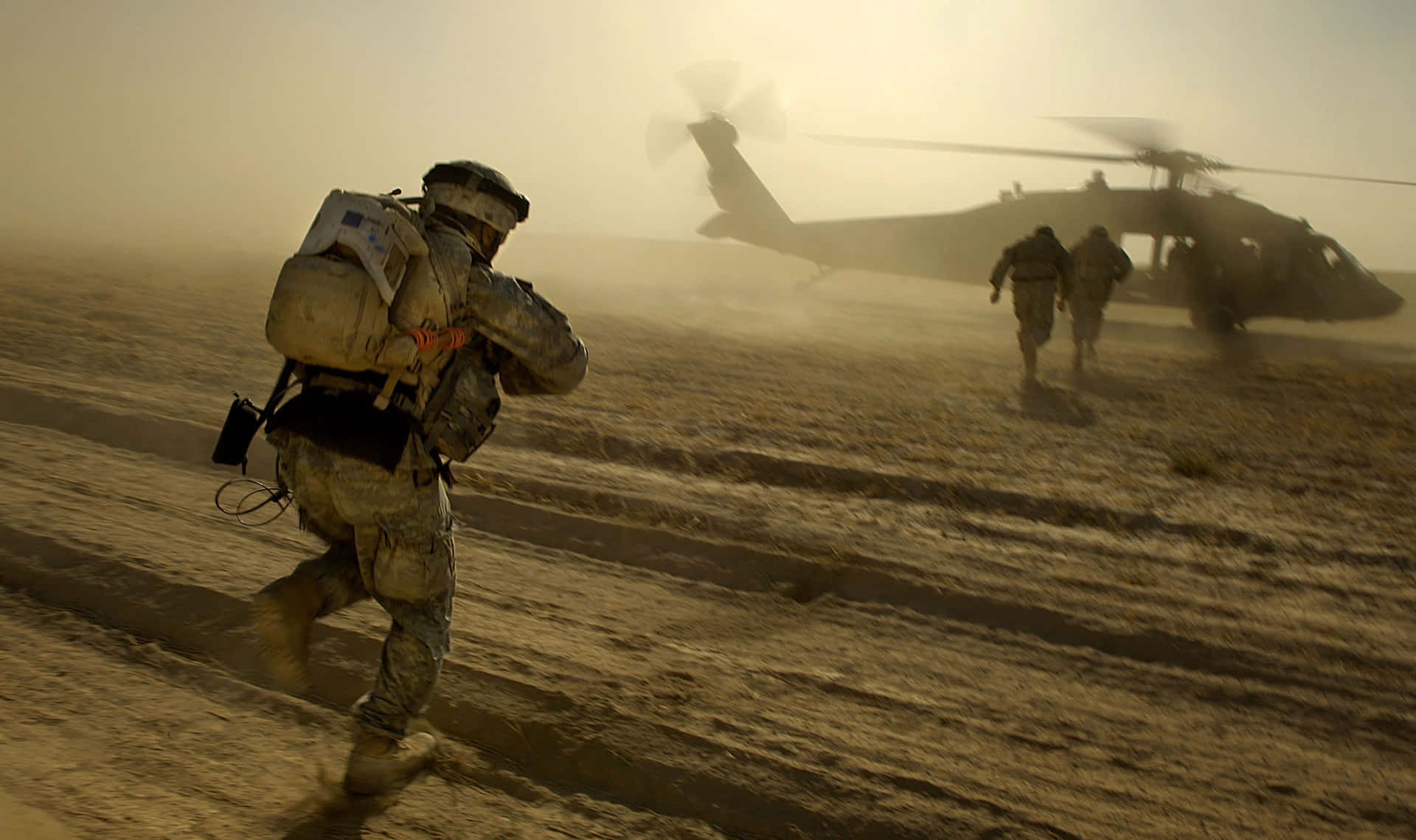 A Soldier Is Running Towards A Helicopter Wallpaper