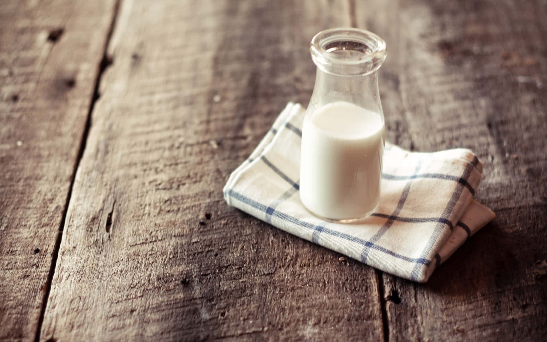A Glass Of Milk On A Wooden Table