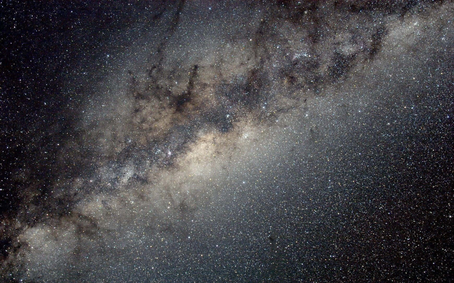 Star-filled Milky Way night sky illuminating the horizon