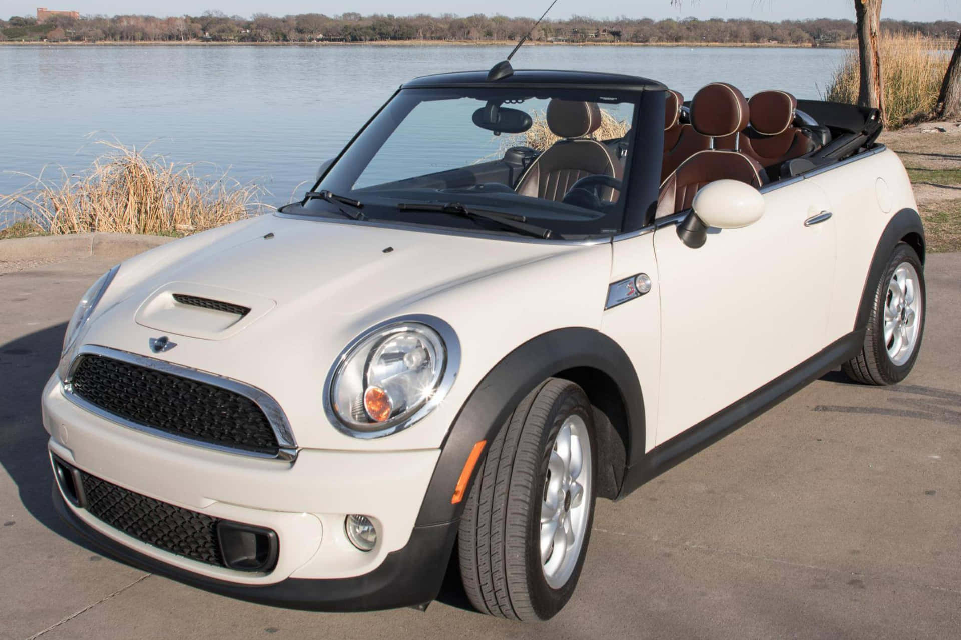 Sporty Mini Cooper Convertible cruising on the open road Wallpaper