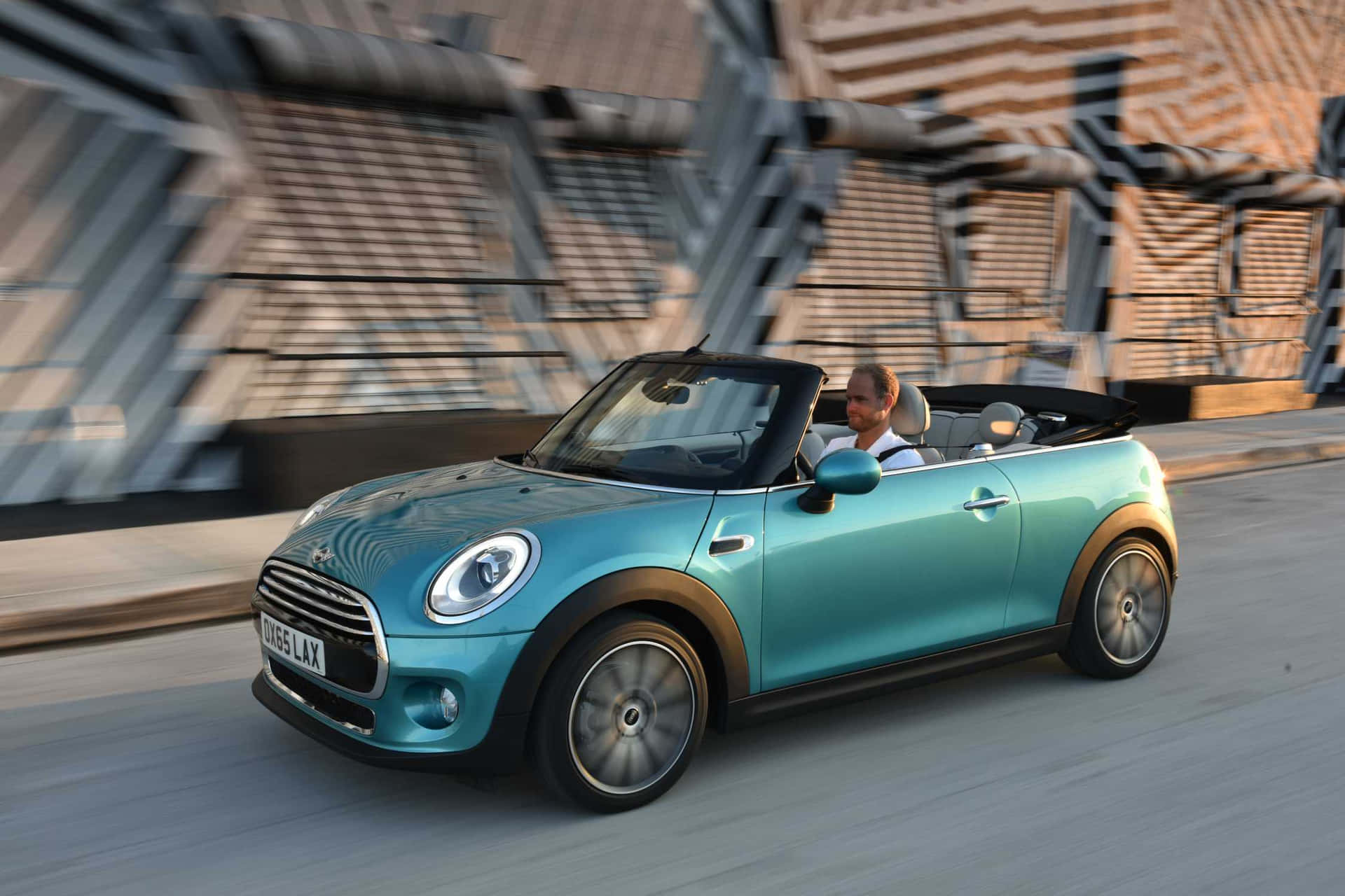 Discover the thrill of driving in the sleek Mini Cooper Convertible Wallpaper