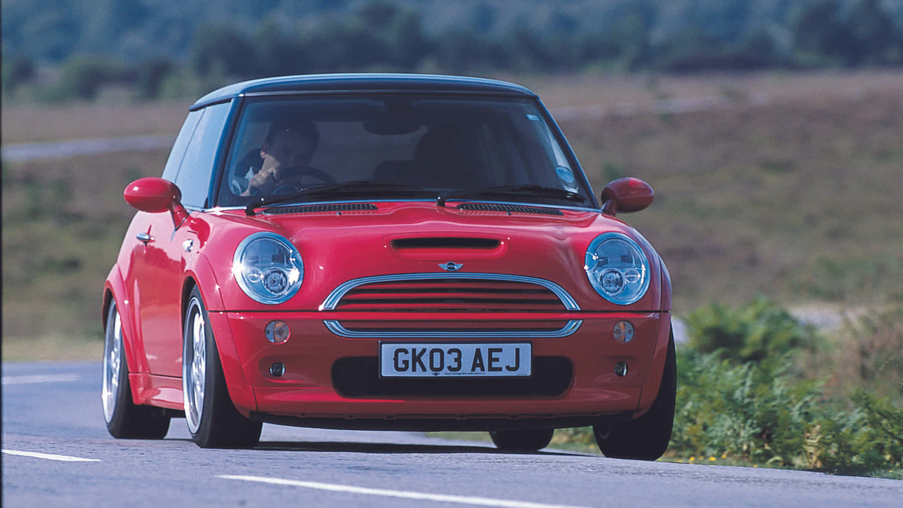 Sporty and Sleek Mini Cooper S on the Open Road Wallpaper