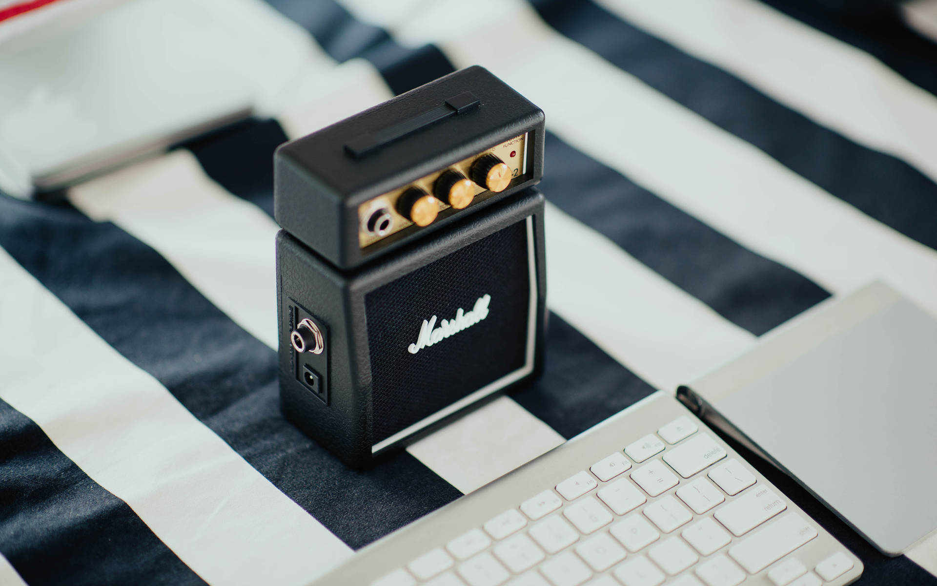 Mini Marshall Amplifier Near Keyboard Background