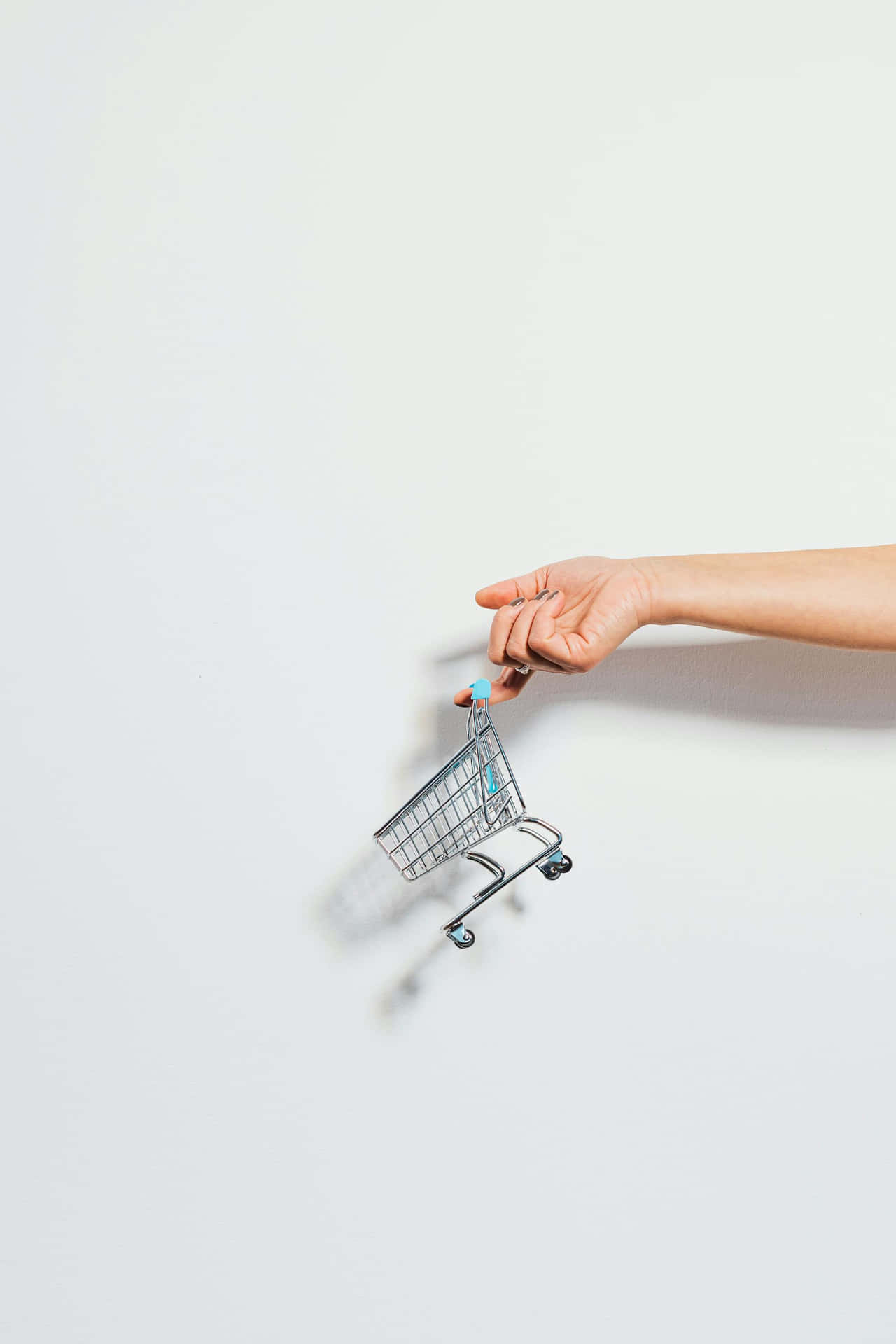 Miniature Shopping Cart Heldby Hand Wallpaper