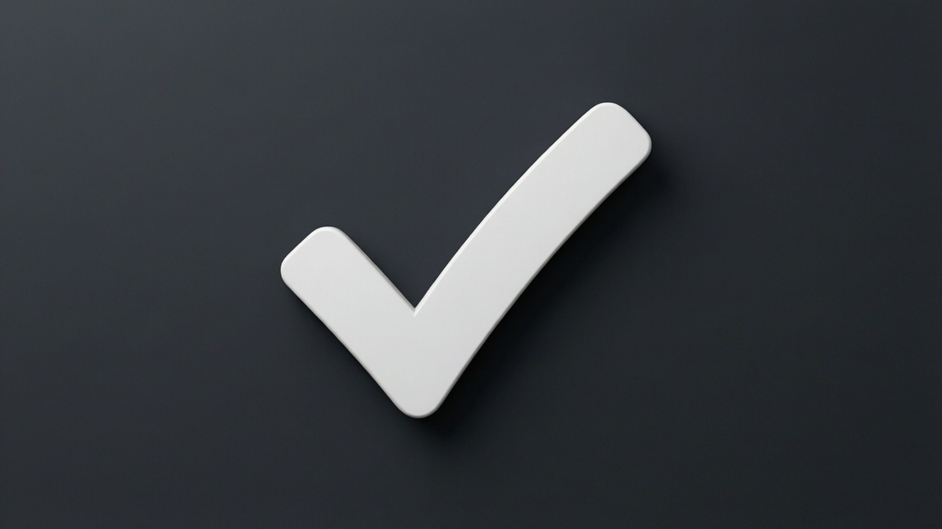 A white checkmark on a dark gray surface indicating completion or approval.