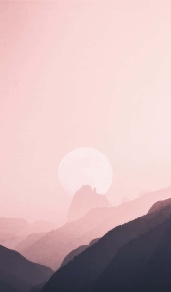 A Pink Sunset Over Mountains And Hills
