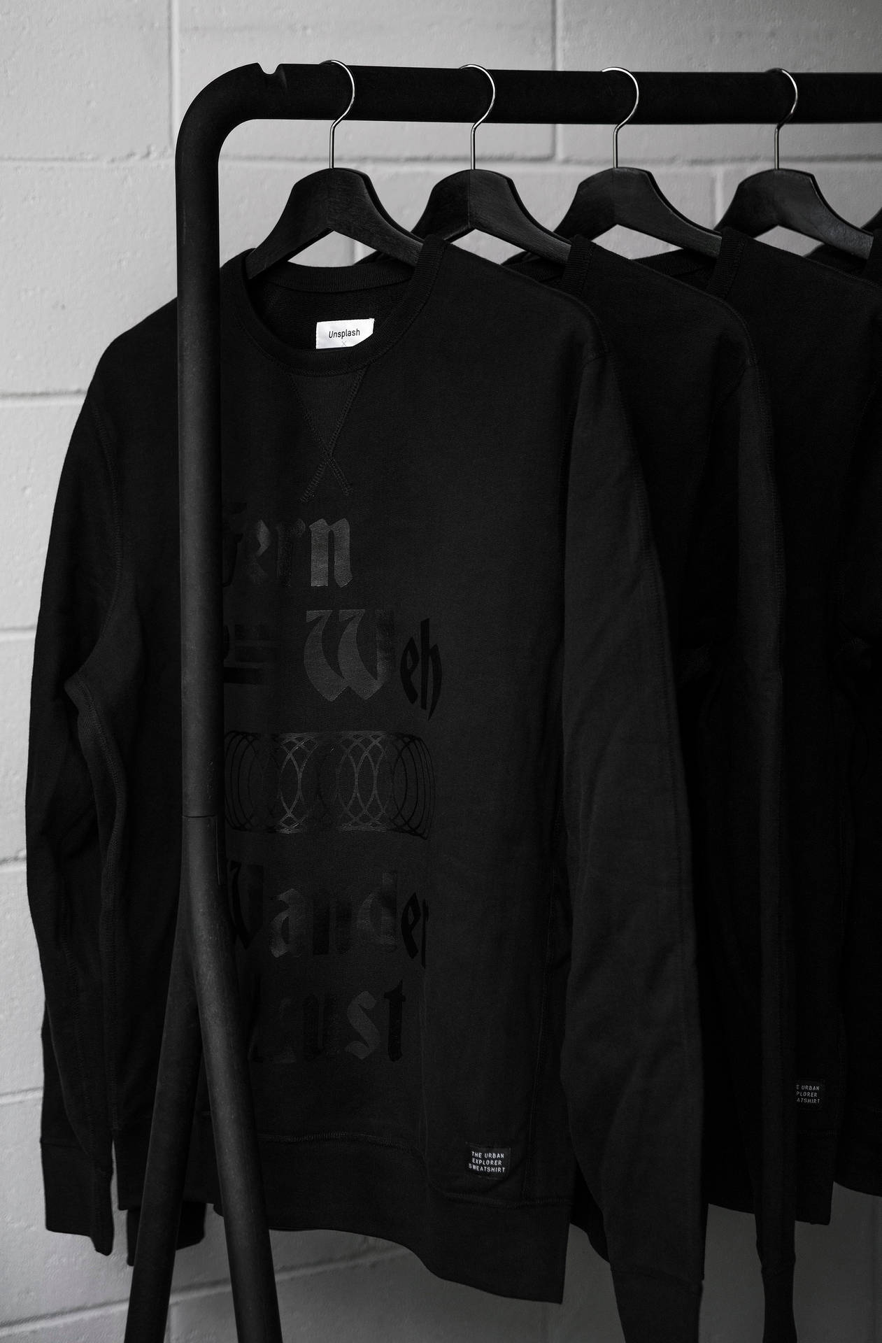 Minimalist Clothes Rack With Sweatshirts Background