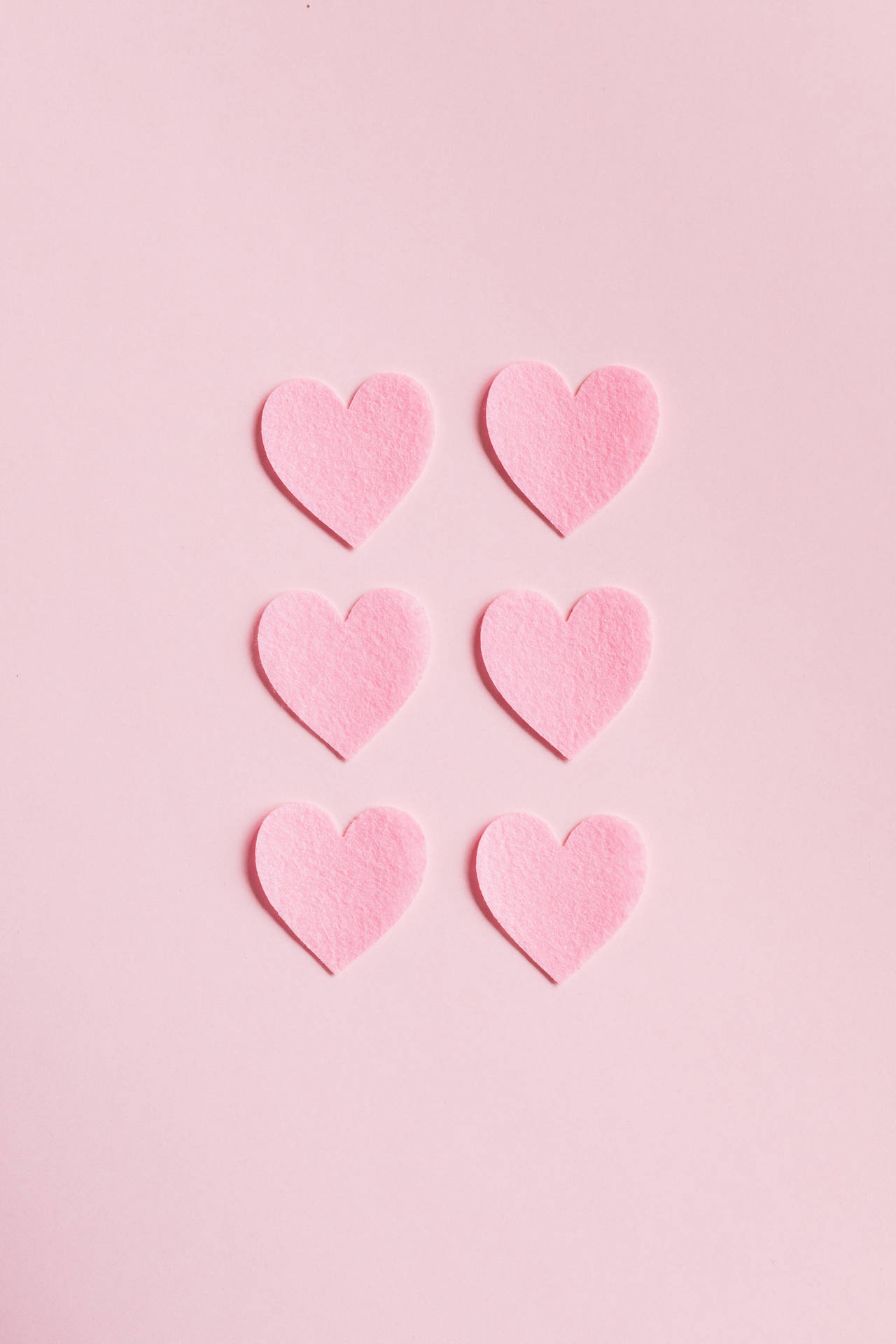 Minimalist Hearts On Pastel Pink Colors Wallpaper