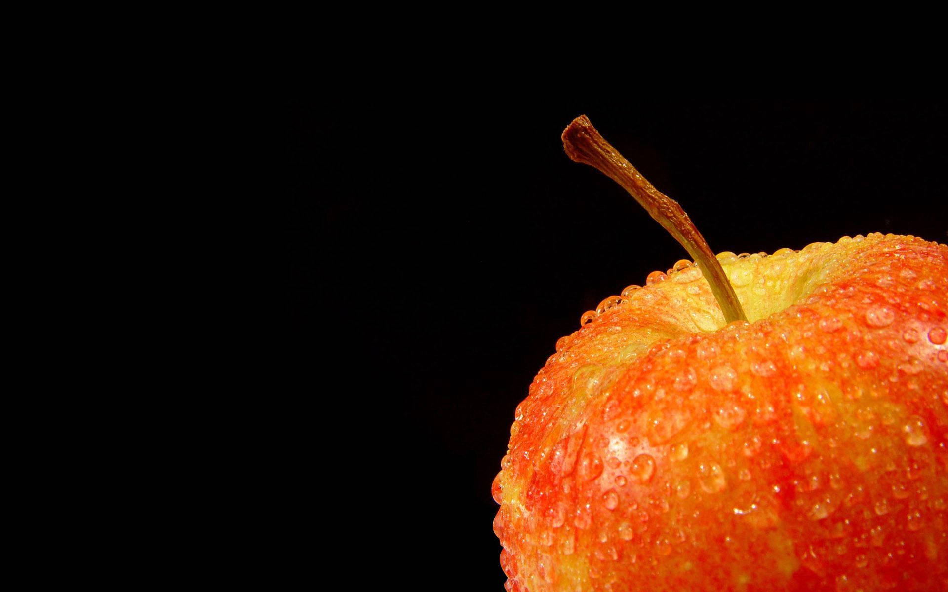 A Red and Black Apple Wet and Glistening Wallpaper