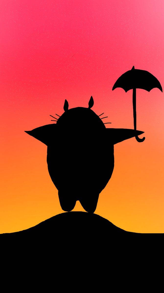 A silhouette of the beloved character Totoro against a backdrop of a beautiful sunset. Wallpaper