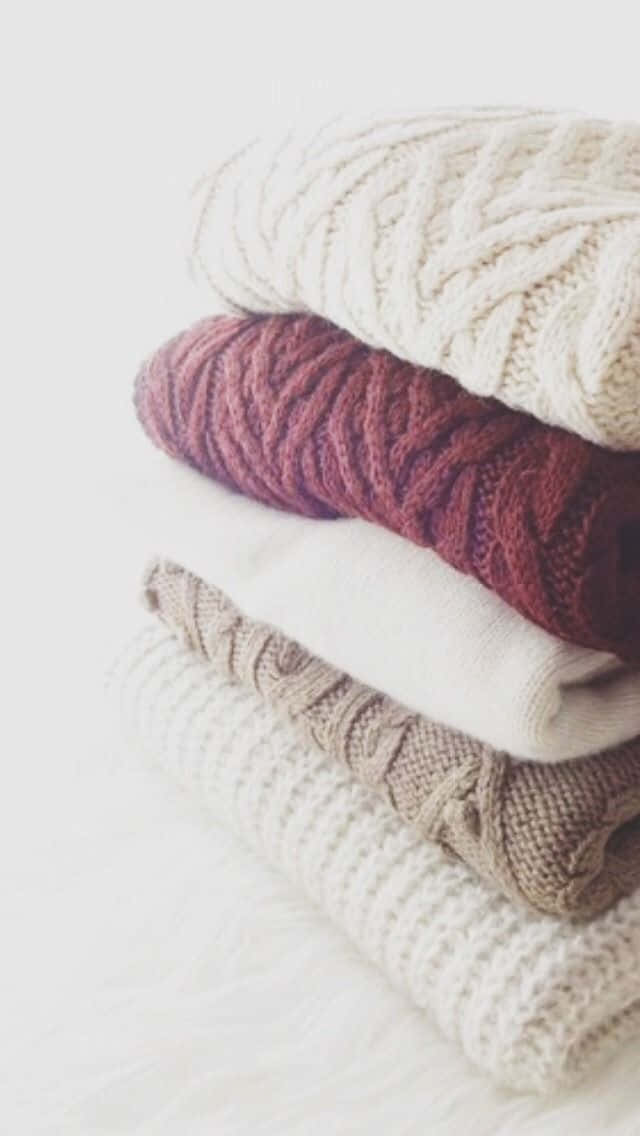 Cozy Minimalistic Sweater Arrangement Wallpaper