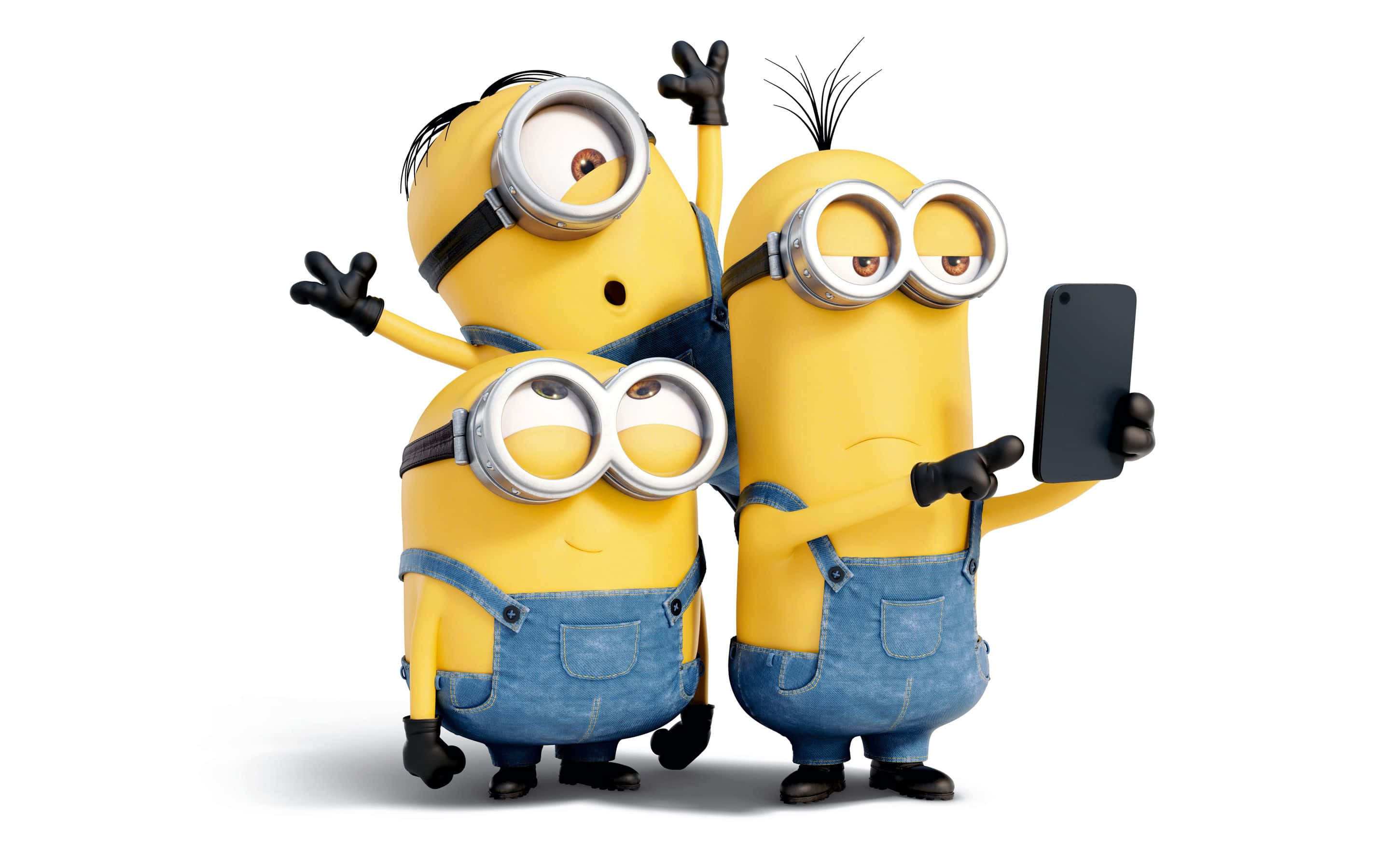 Download Description- Three Minions from the popular Despicable Me  franchise standing side by side, dressed up in colorful overalls with  smiling faces full of mischief.
