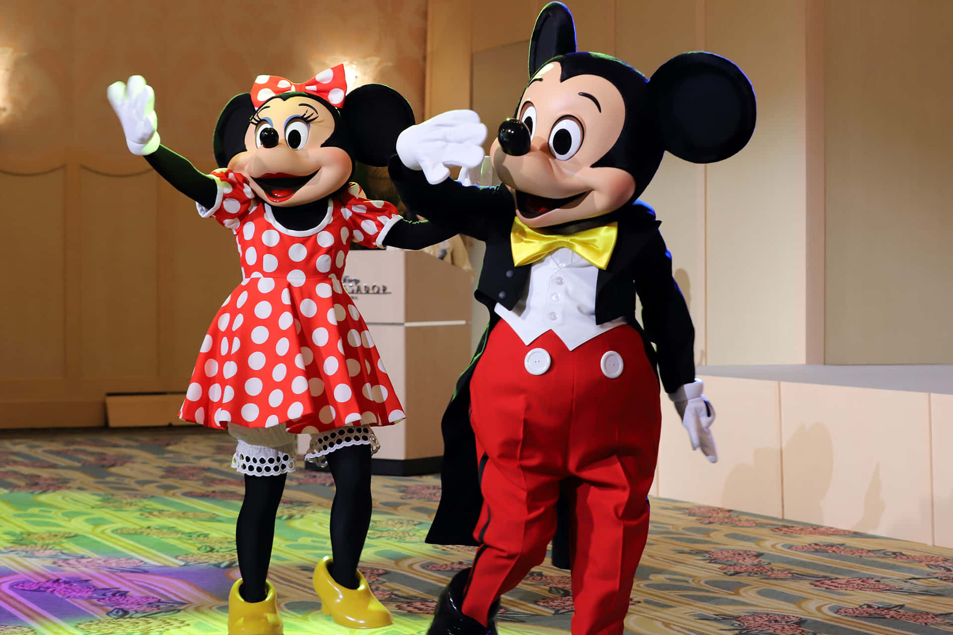 Two Mickey Mouse Mascots Dancing On Stage