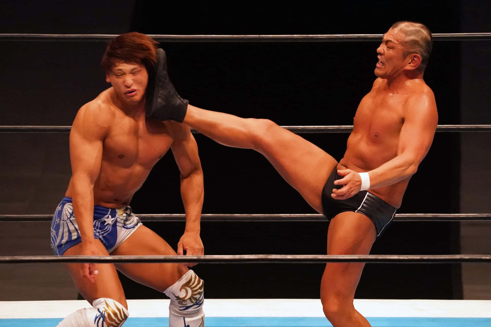 Wrestler Minoru Suzuki Lethal Kick on Kota Ibushi in the Ring Wallpaper