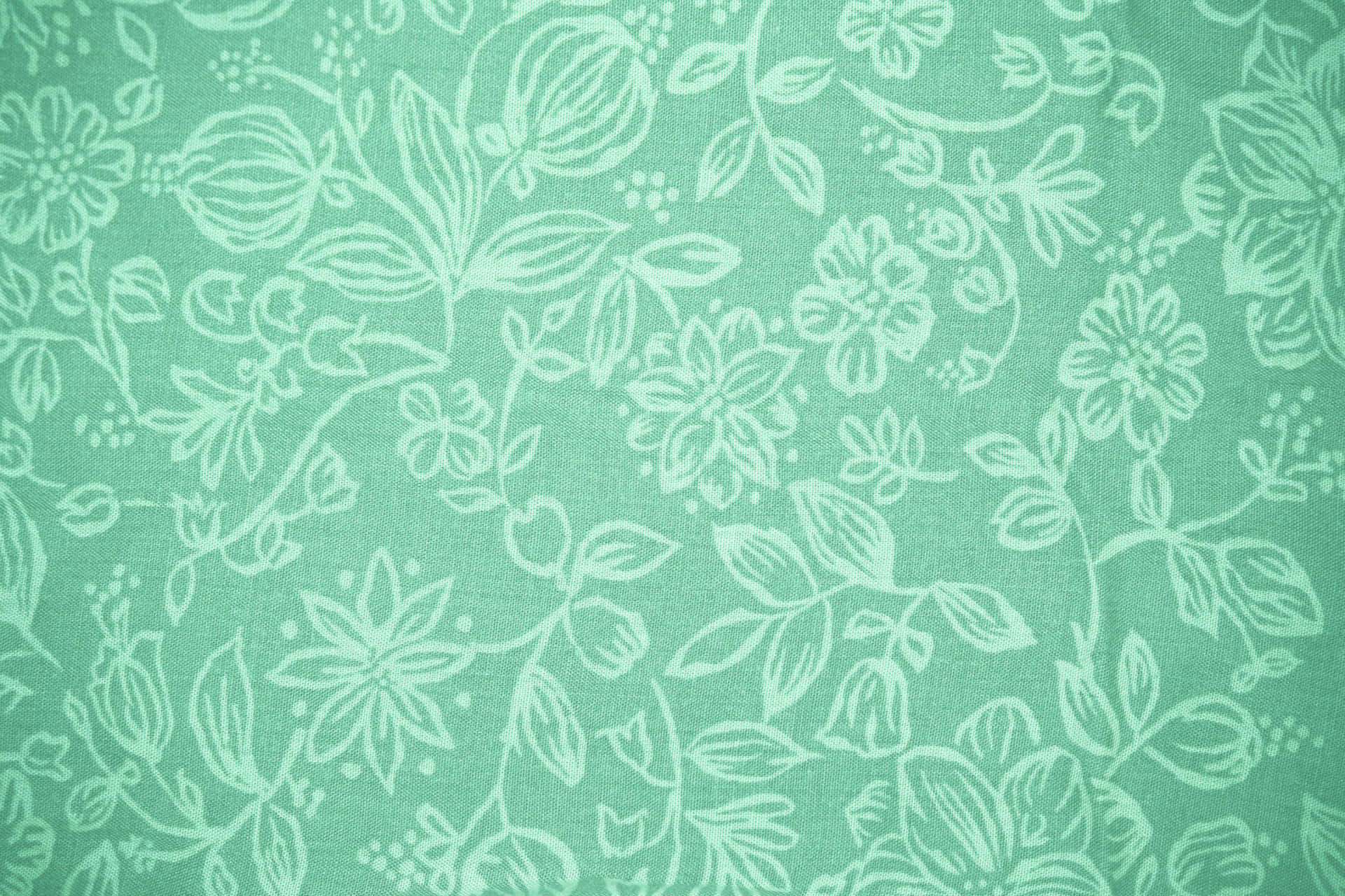A Green Floral Pattern On A Fabric