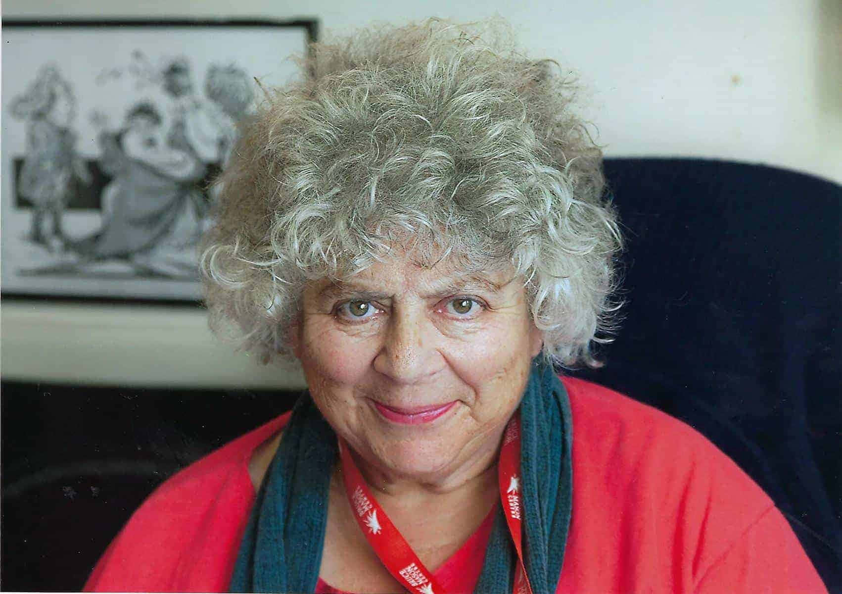 Miriam Margolyes Giving A Radiant Smile In An Authentic Portrait Shot Wallpaper