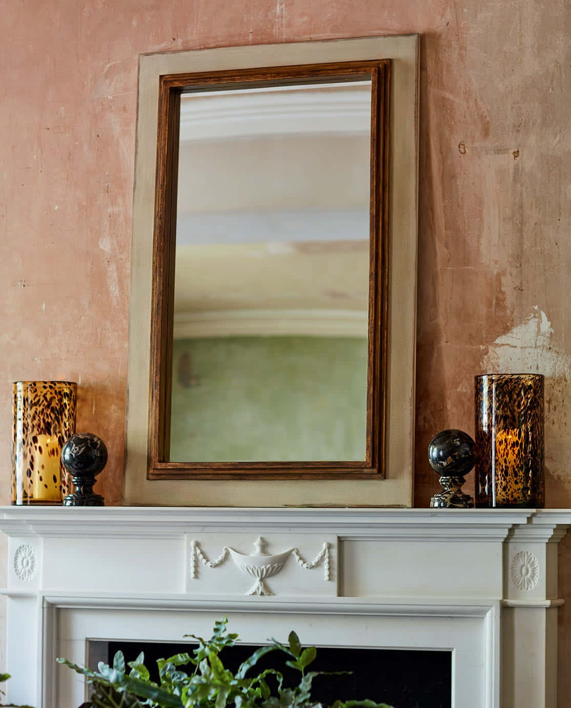 A Fireplace With A Mirror Above It