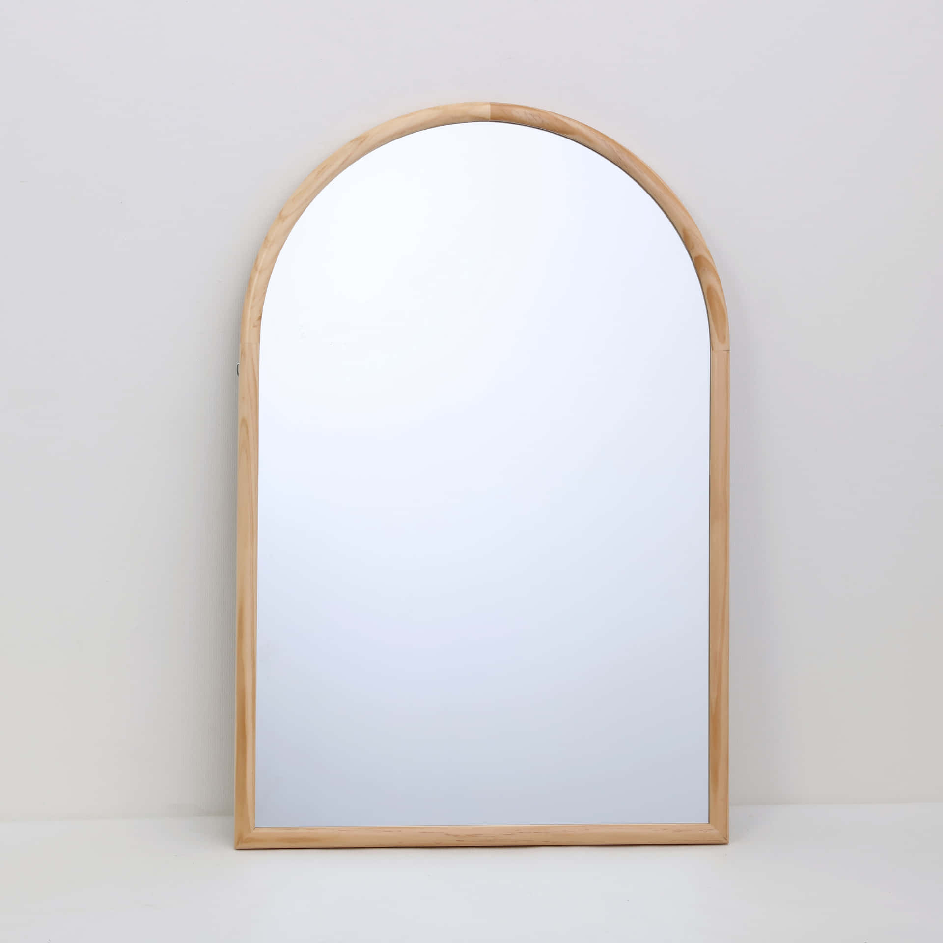 A Wooden Mirror With A Wooden Frame