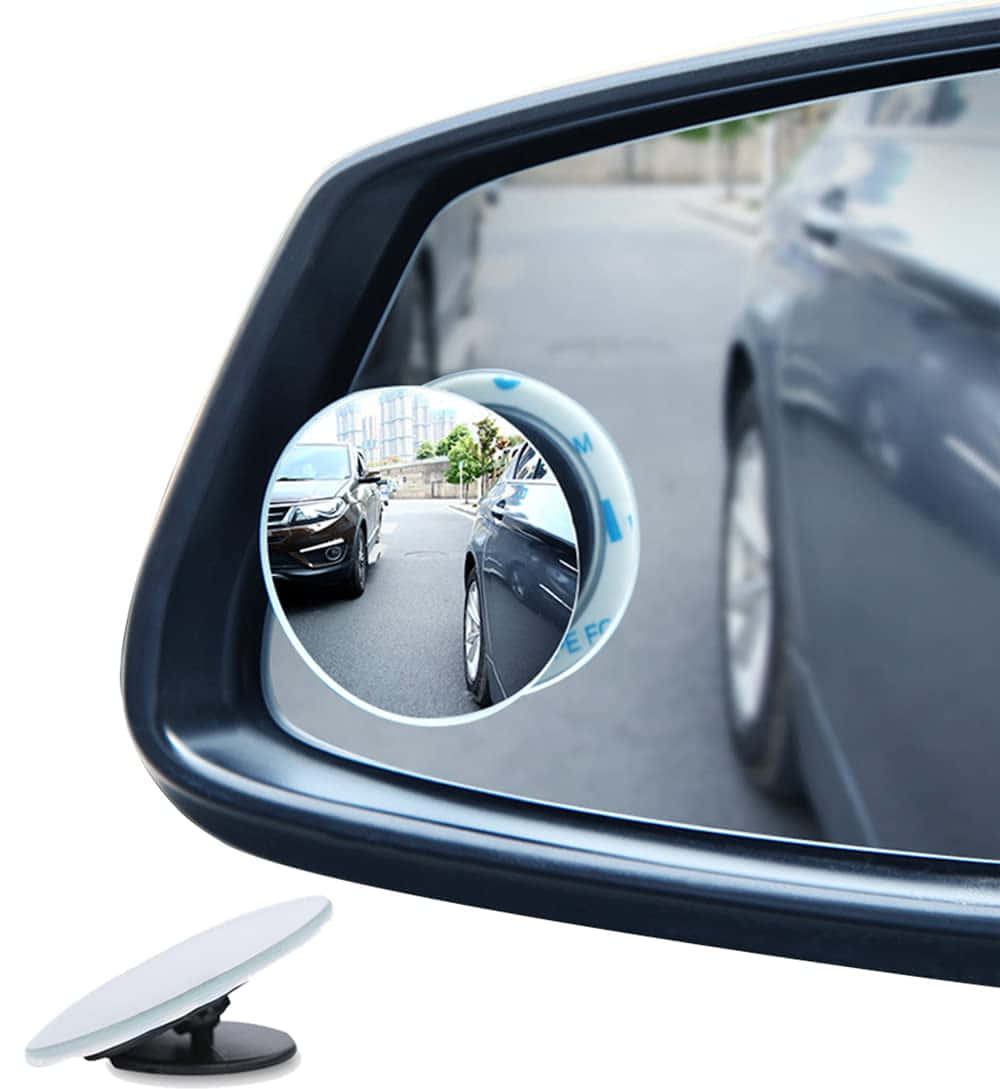 A Car Side Mirror With A Car In The Background