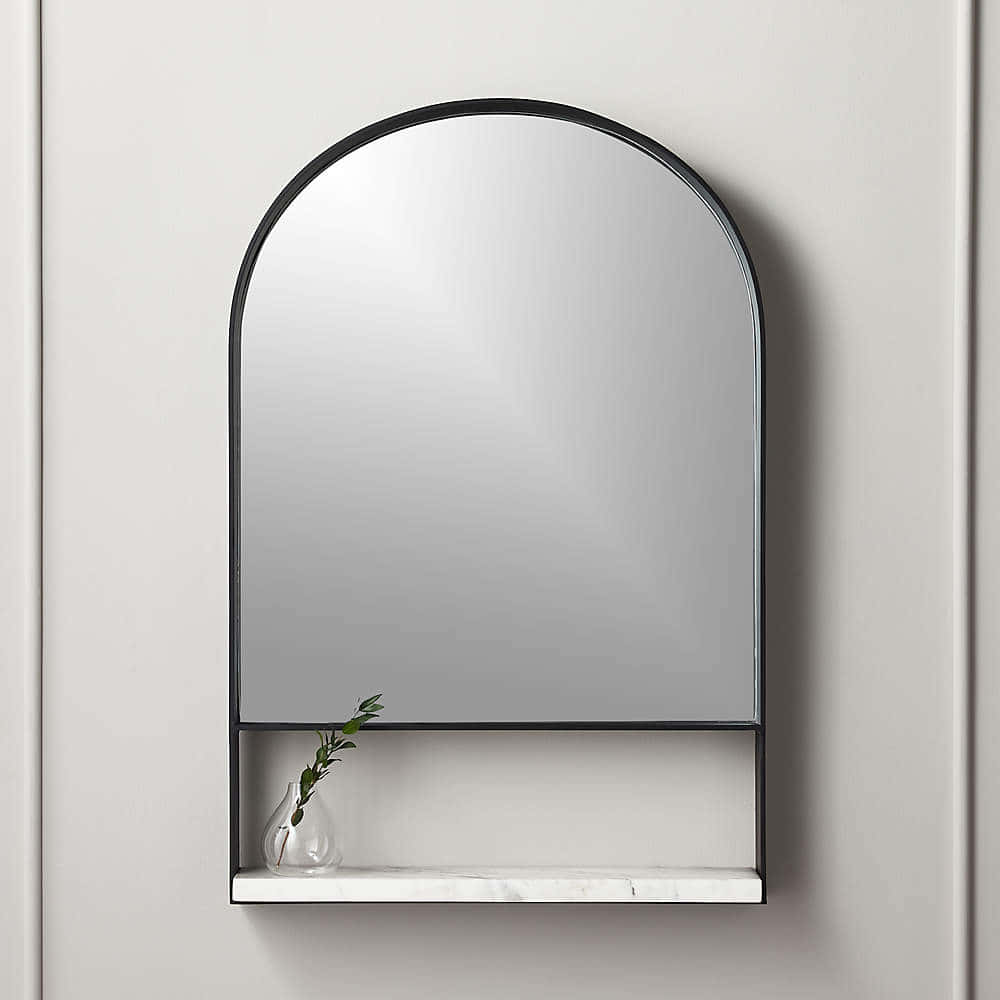 A Mirror With A Shelf And A Vase On It