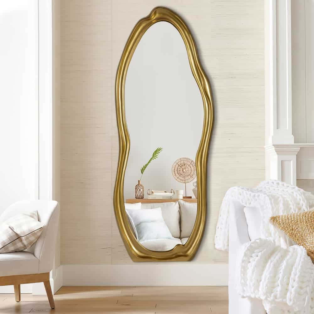 A Gold Framed Mirror In A Living Room