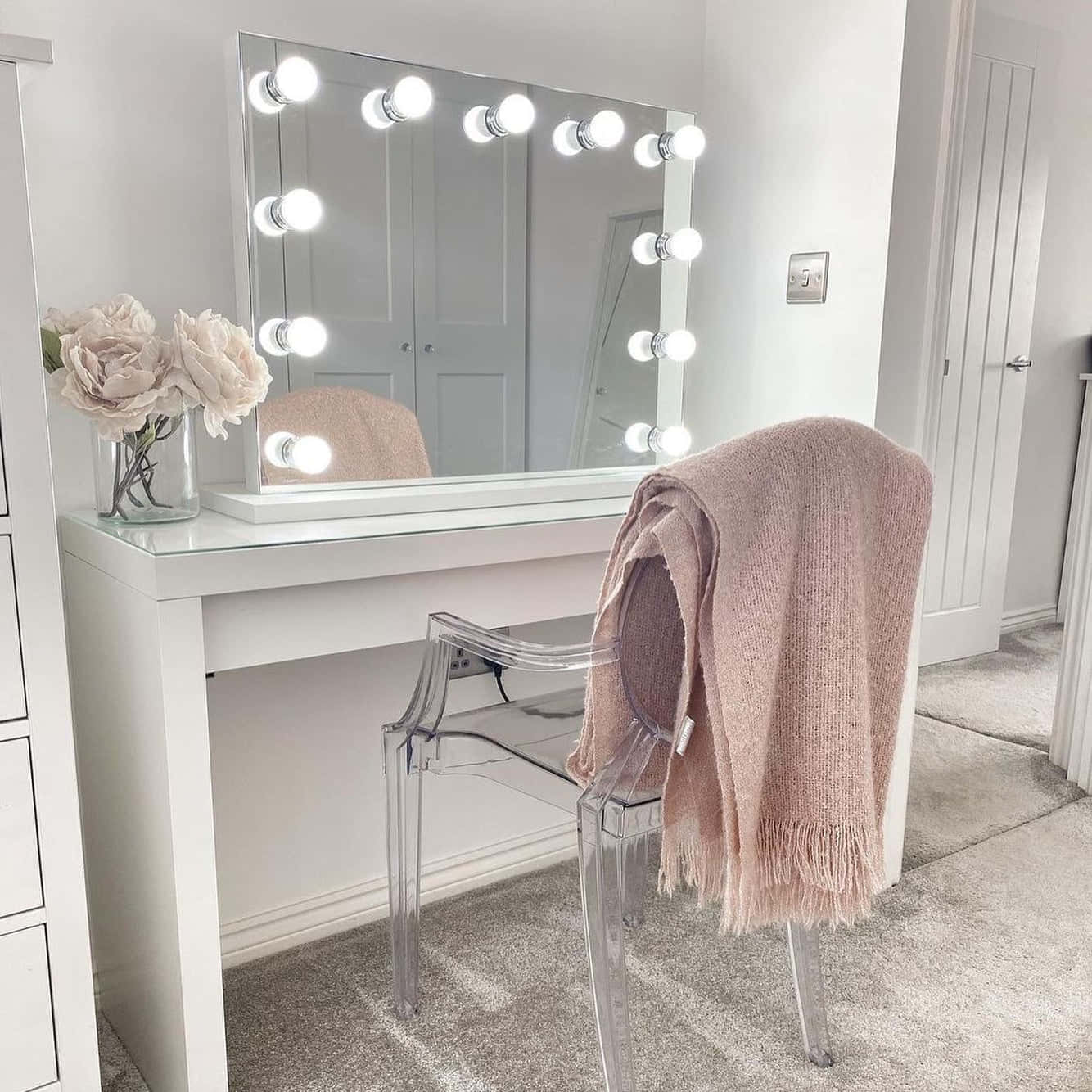 A White Vanity With A Mirror And A Chair