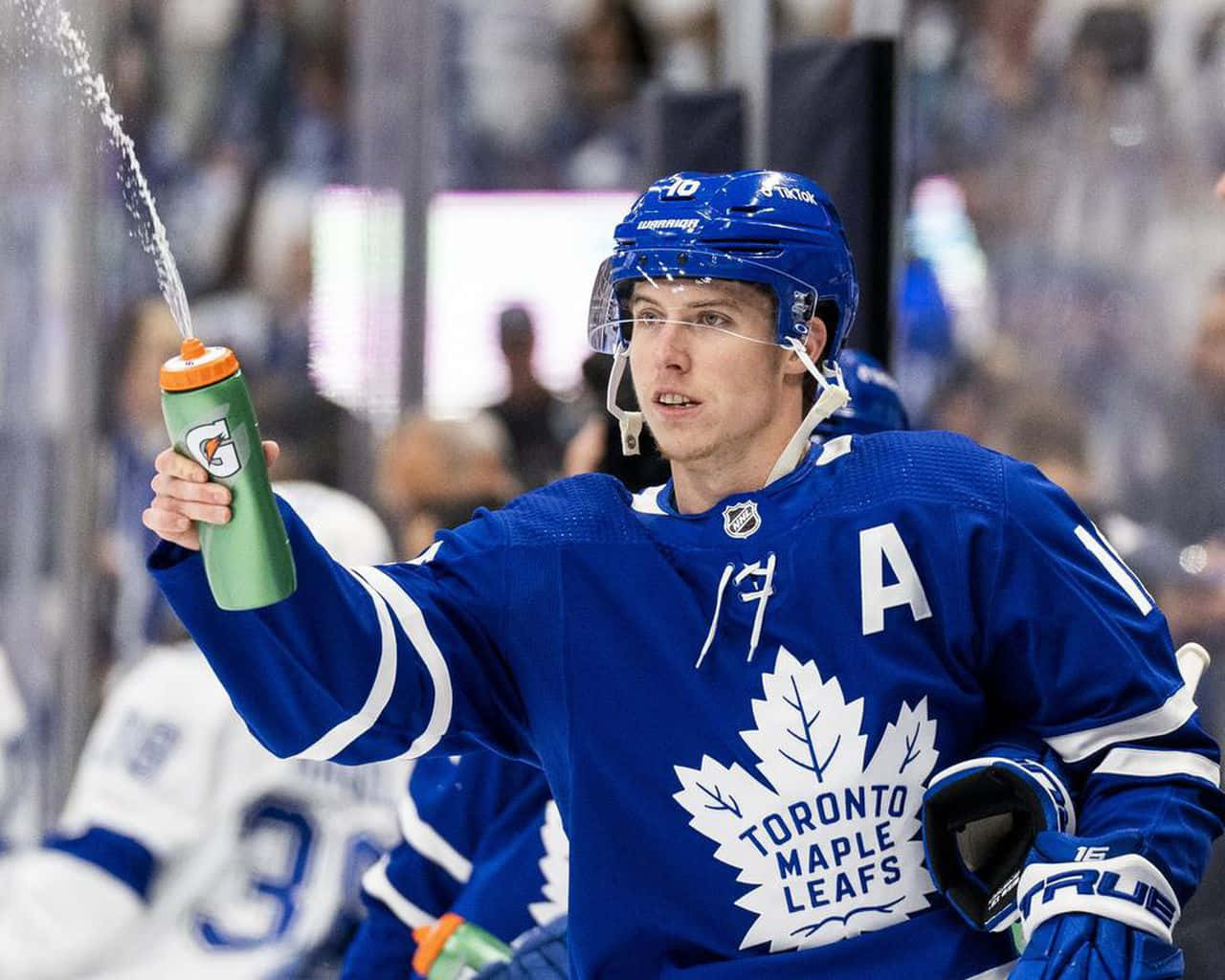 Mitchell Marner Squeezing a Gatorade Bottle During a Game Wallpaper