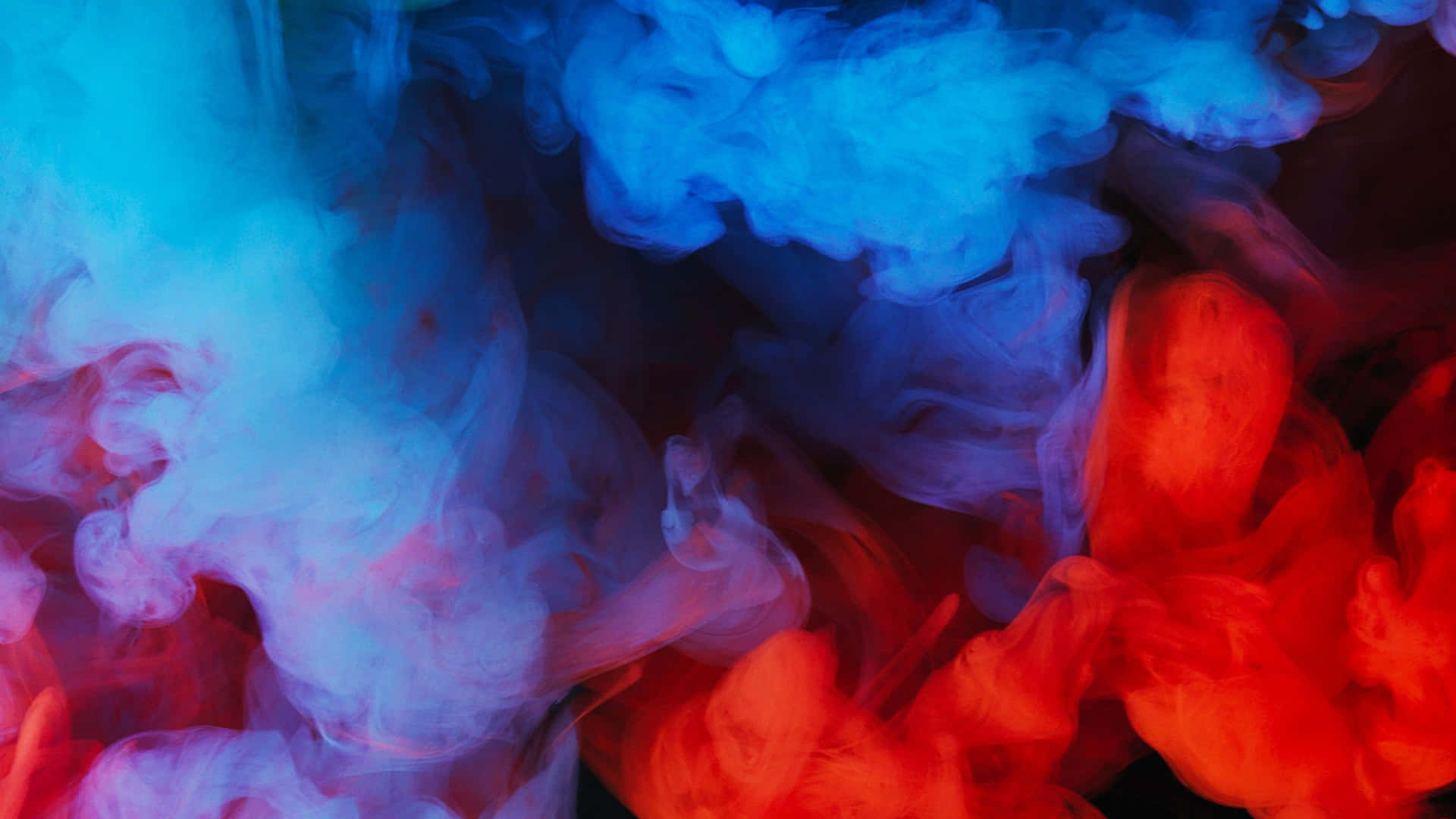 A Blue, Red And Blue Smoke Is Floating In The Air