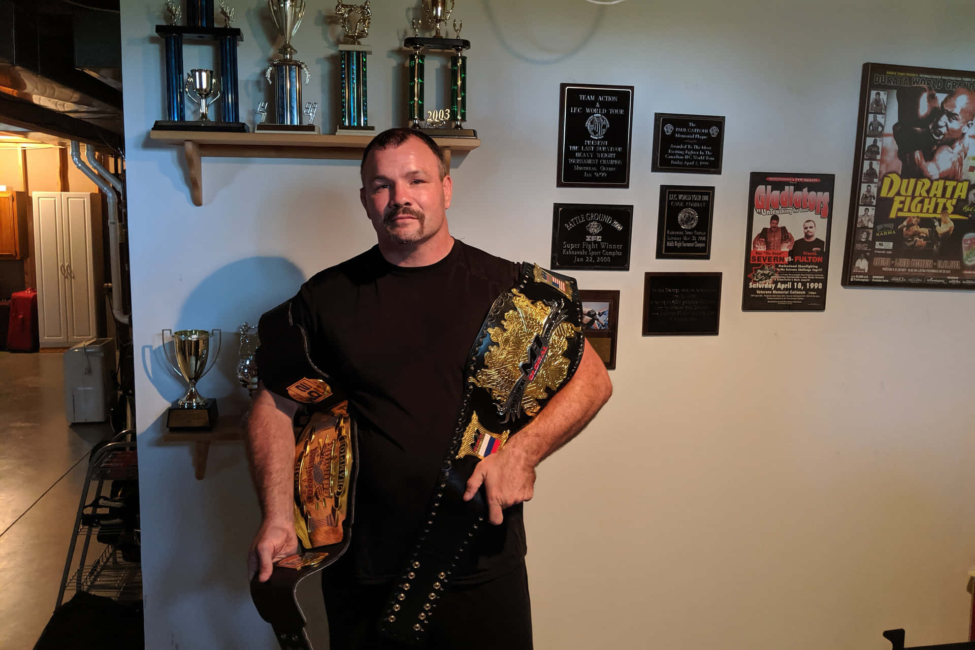Mixed Martial Artist Travis Fulton And His Championship Belts Picture