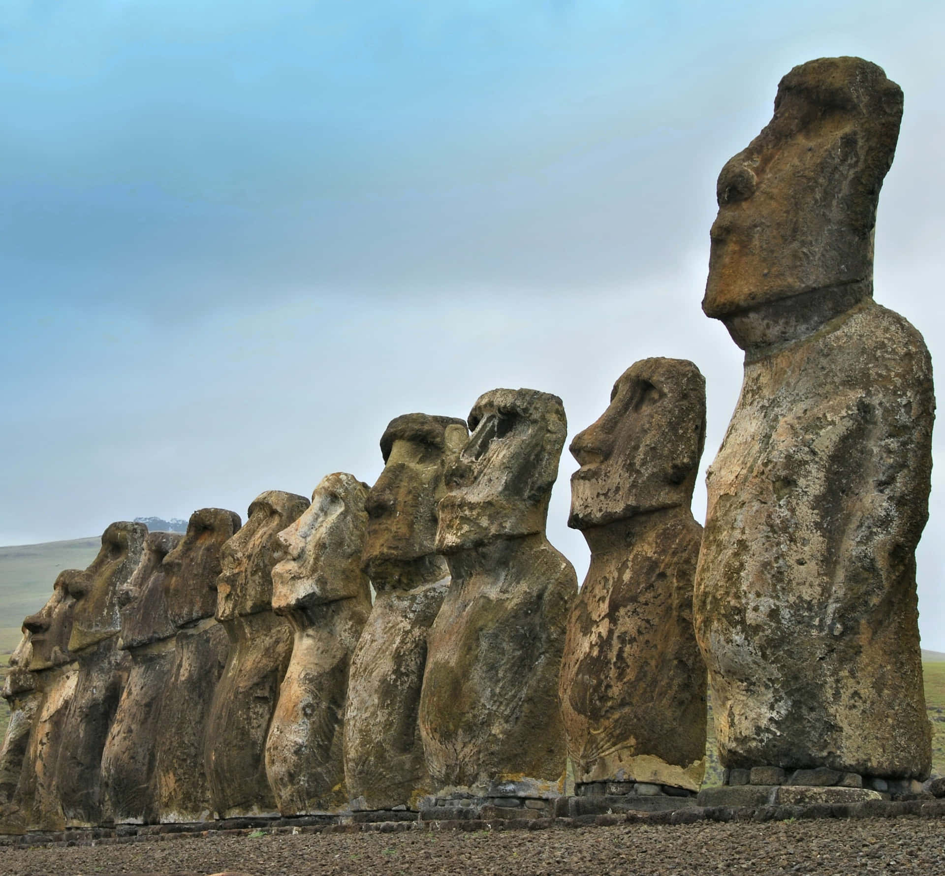 Majestic Row of Moai Statues on Stone Platform Wallpaper