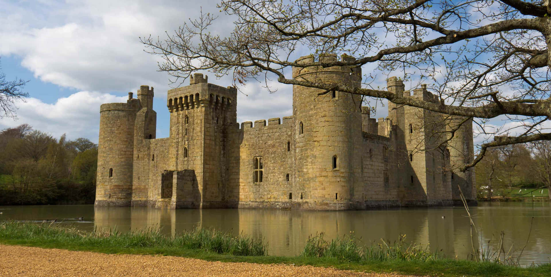 Moated Bodiam Castle In England With Dried Trees Wallpaper