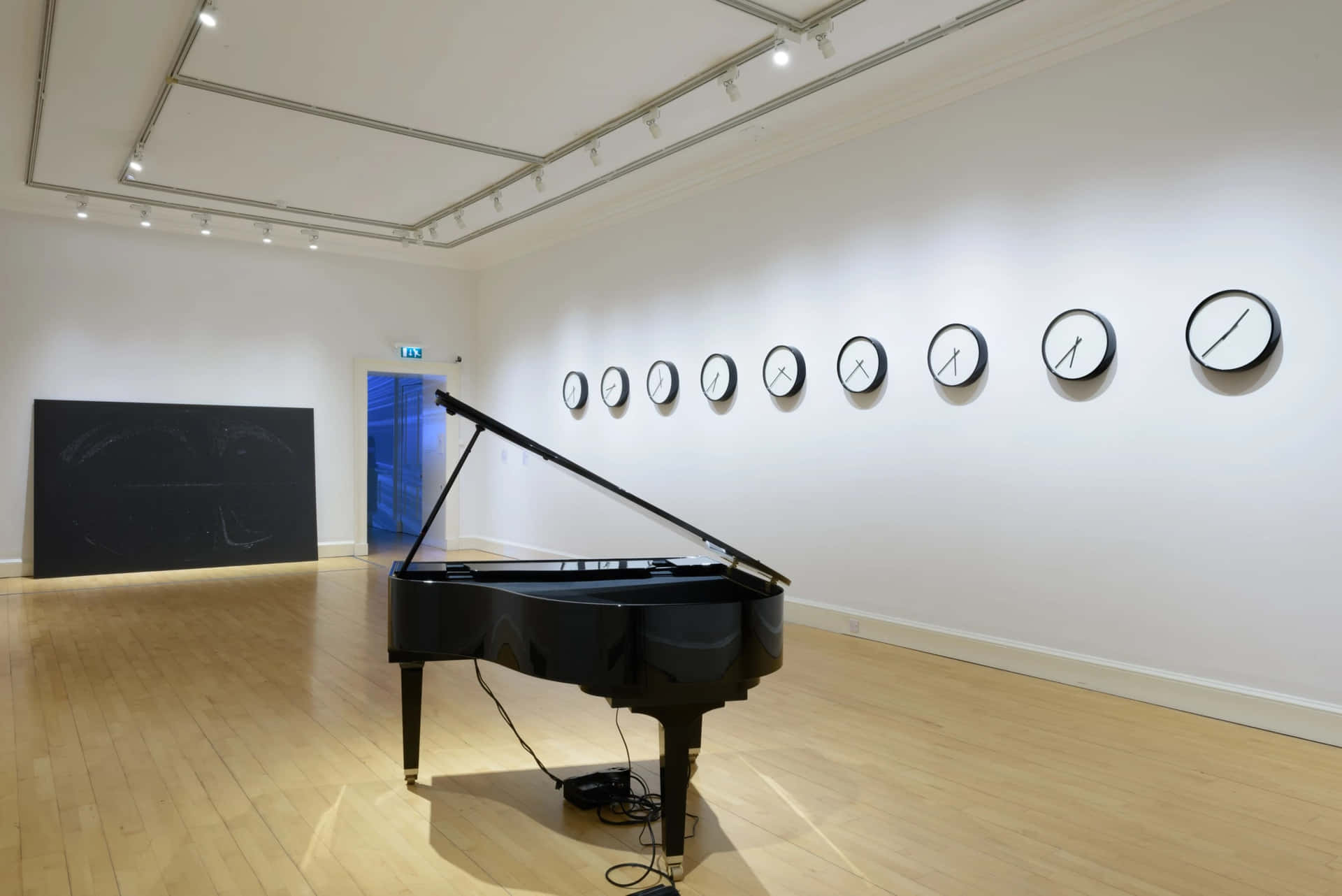 Download Modern Art Gallery Exhibitionwith Piano Wallpaper | Wallpapers.com