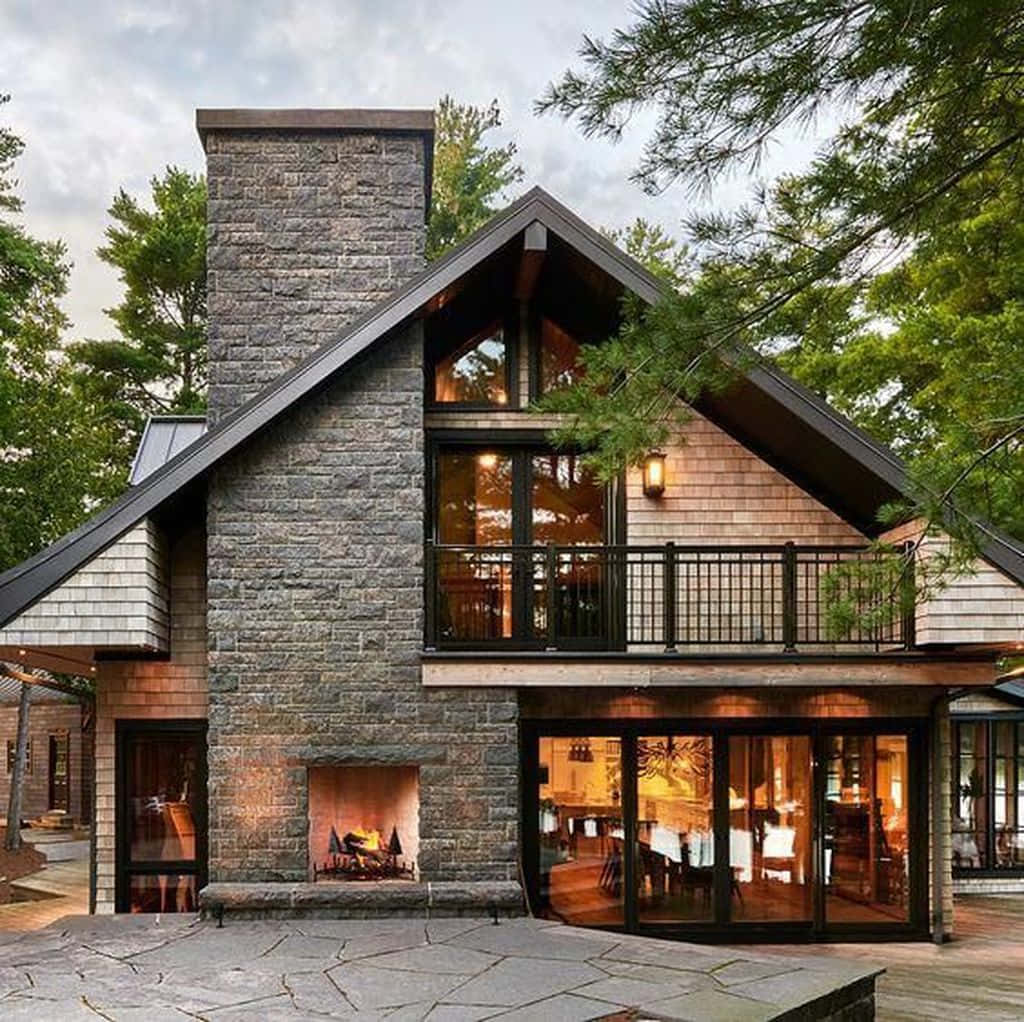 A Modern Home With A Stone Fireplace And Deck