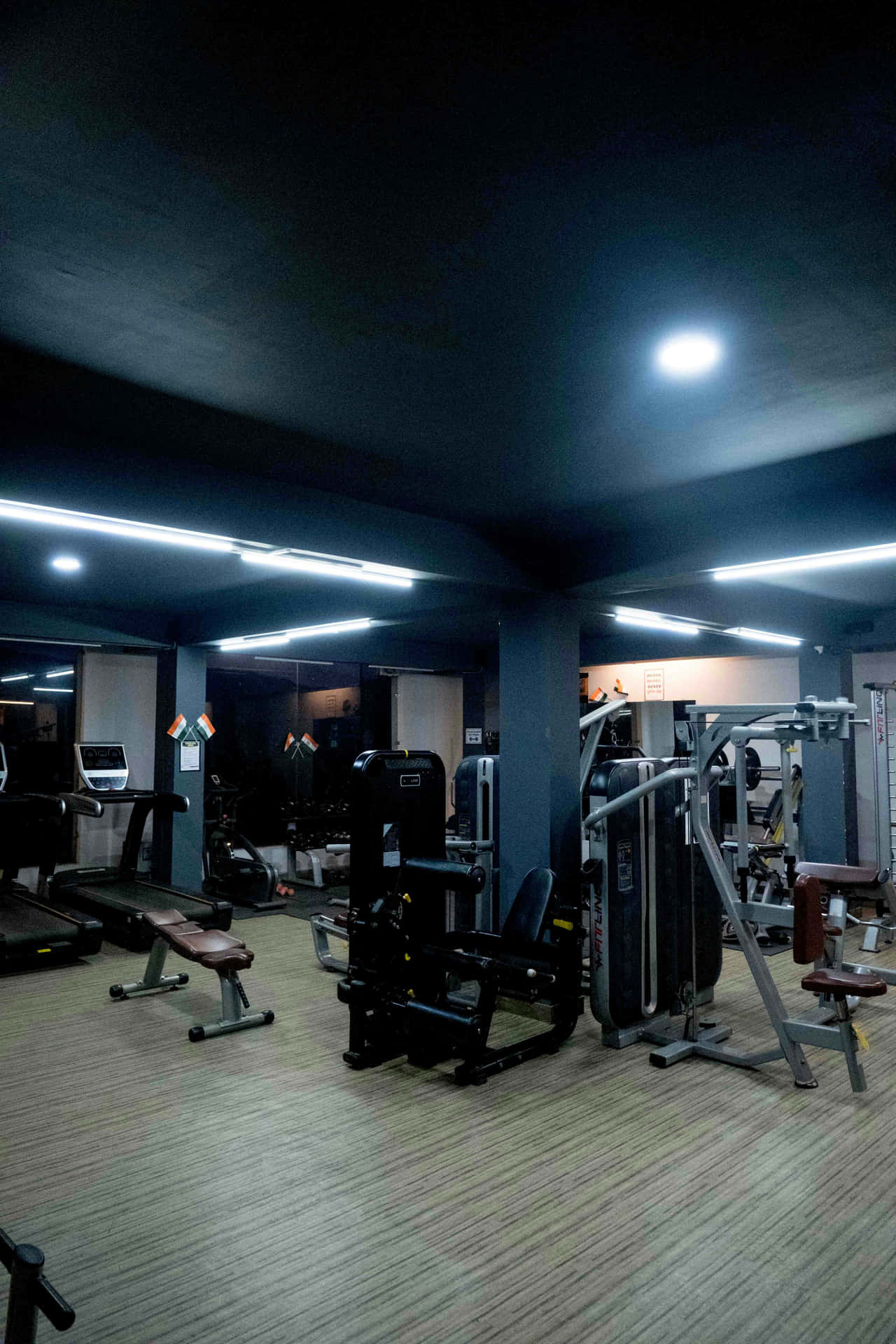 Modern Gym Interior Under Soft Lighting Wallpaper