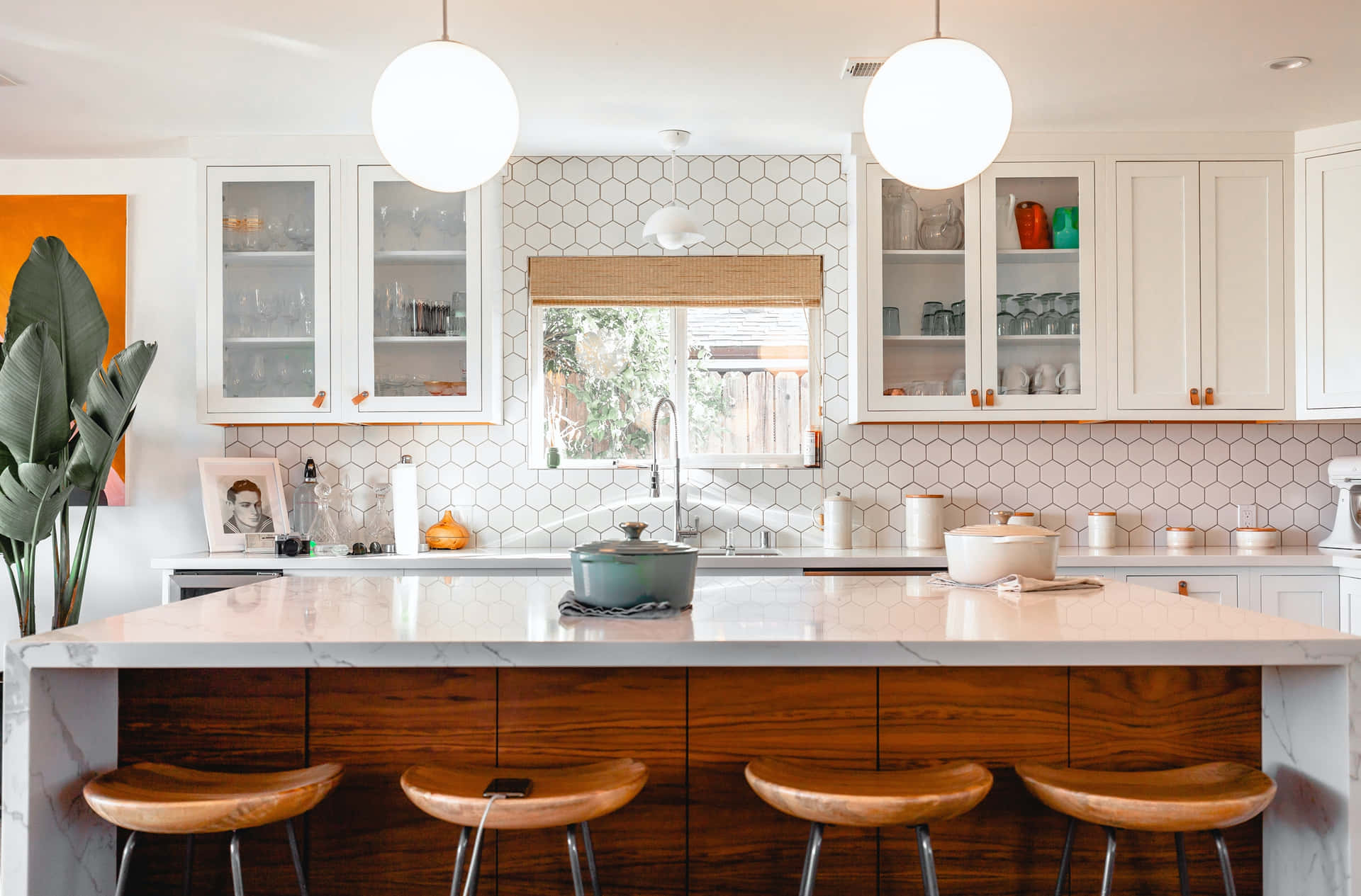 A Kitchen With A Large Island And Stools Wallpaper