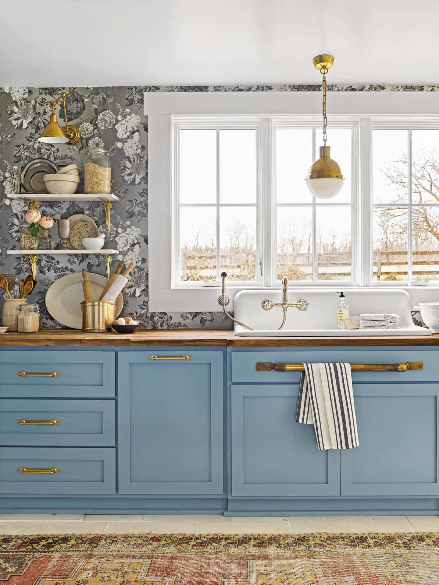 A Blue Kitchen With A Rug And Blue Cabinets Wallpaper