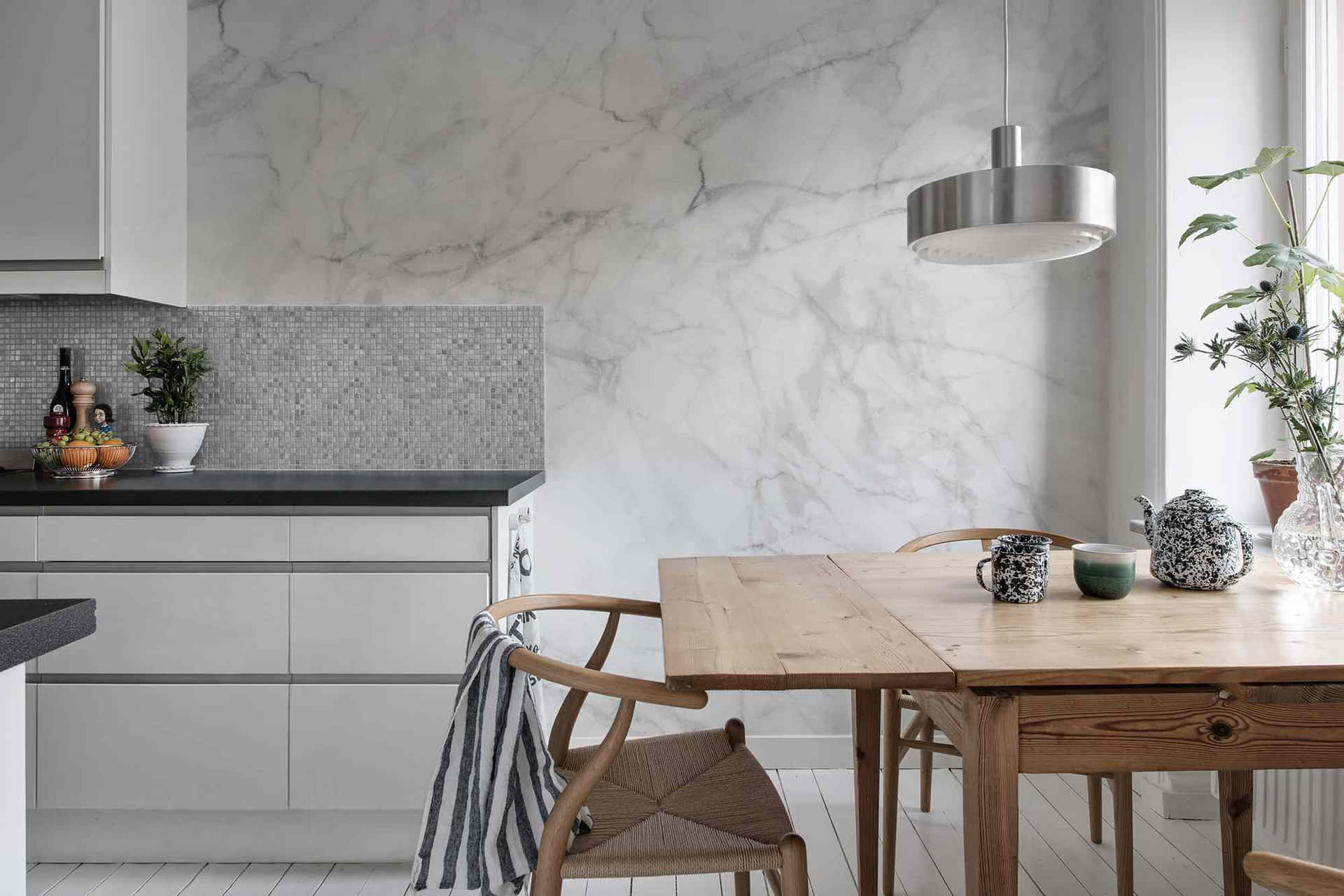 A White Kitchen With Marble Walls And Wooden Table Wallpaper